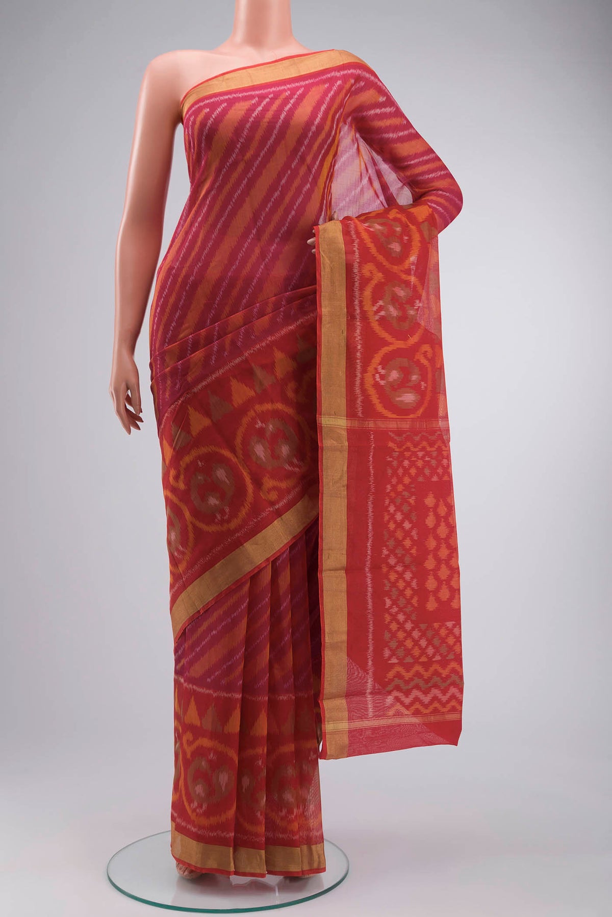 Multi Color Silk Cotton Saree with Ikat Print on the body and Zari Border displayed on a mannequin