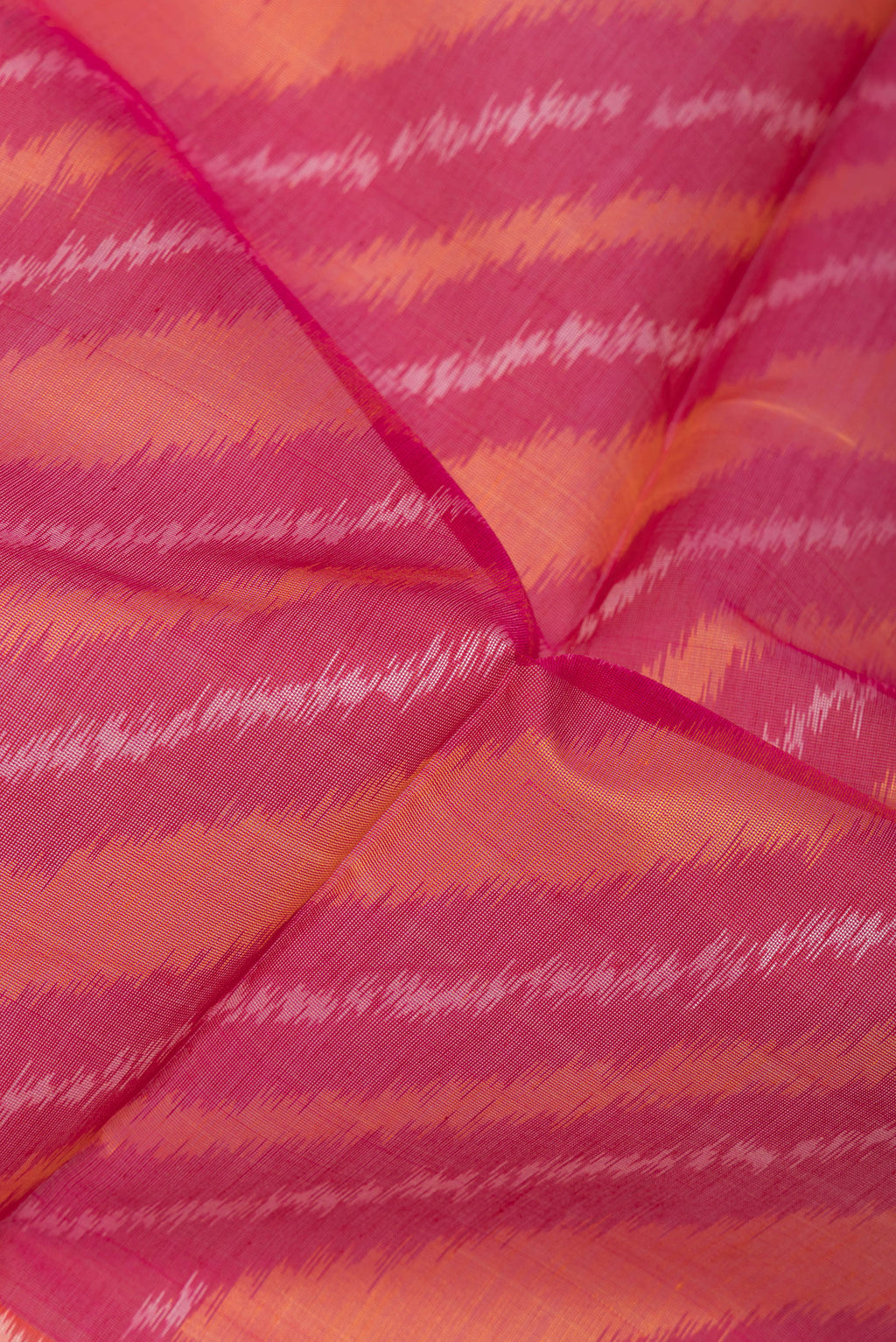 Close up of Multi Color Silk Cotton Saree with Ikat Print on the body and Ikat Border.  displaying folds