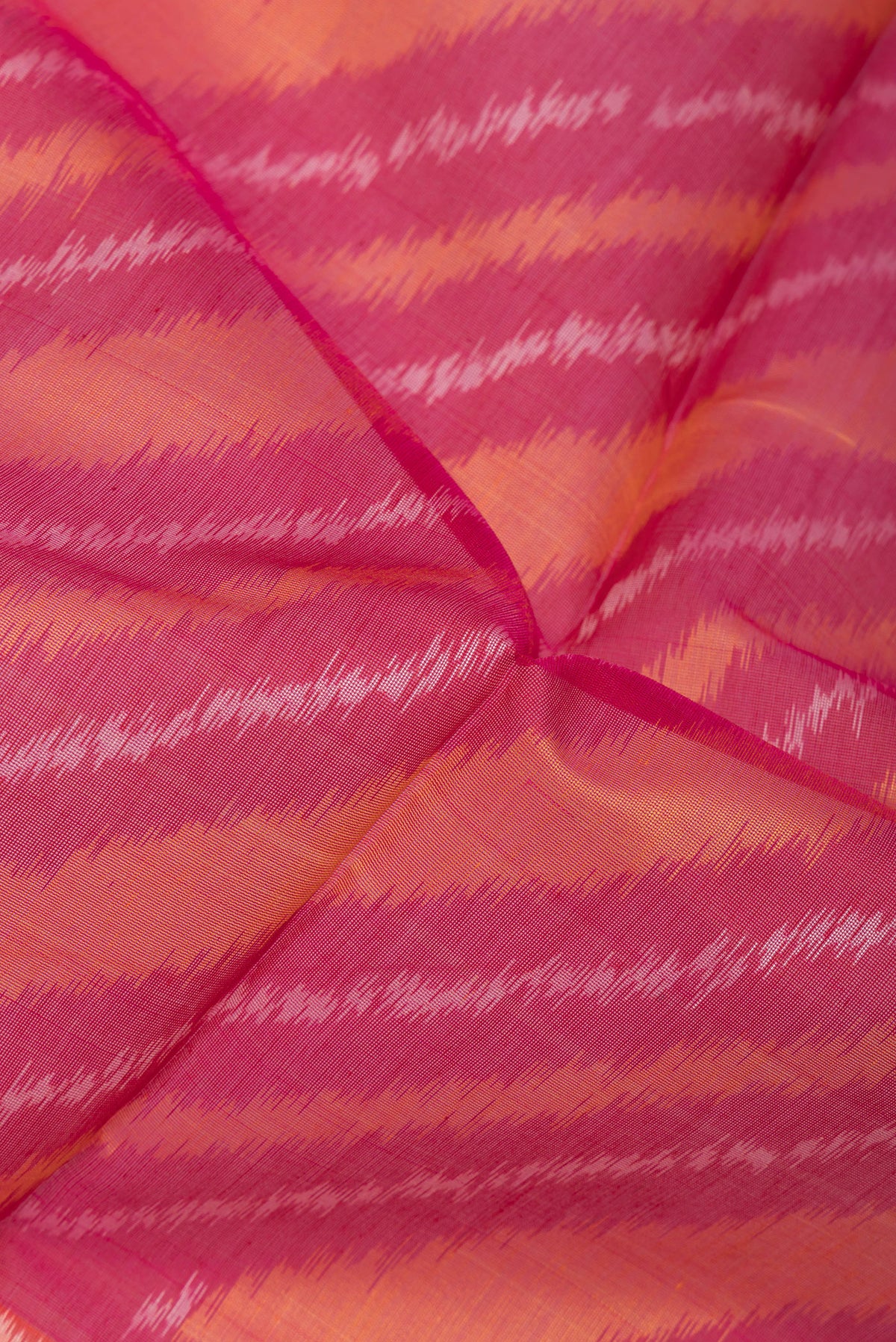 Close up of Multi Color Silk Cotton Saree with Ikat Print on the body and Ikat Border.  displaying folds