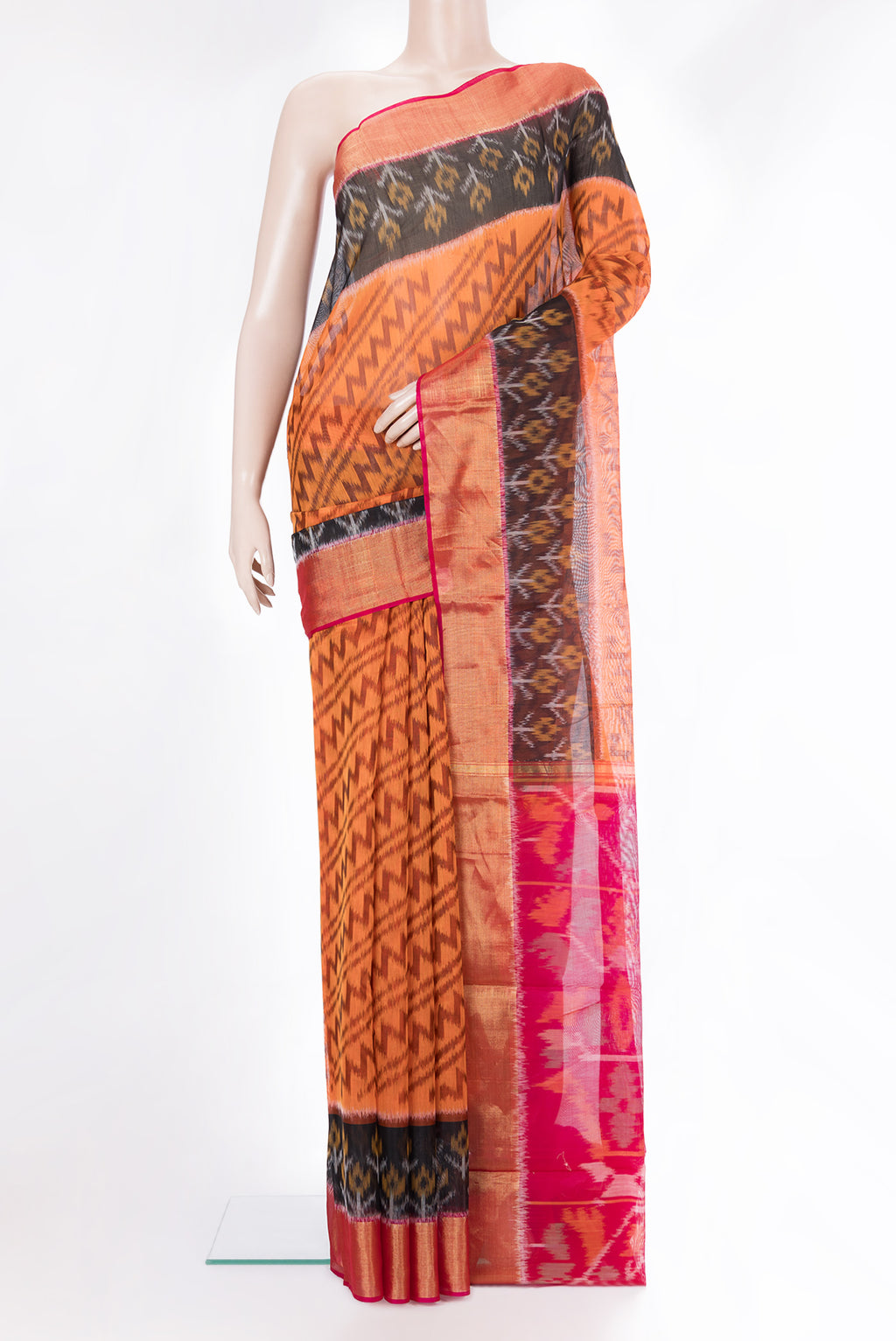Orange Silk Cotton Saree with Ikat Print on the body and Ikat Border.  displayed on a mannequin