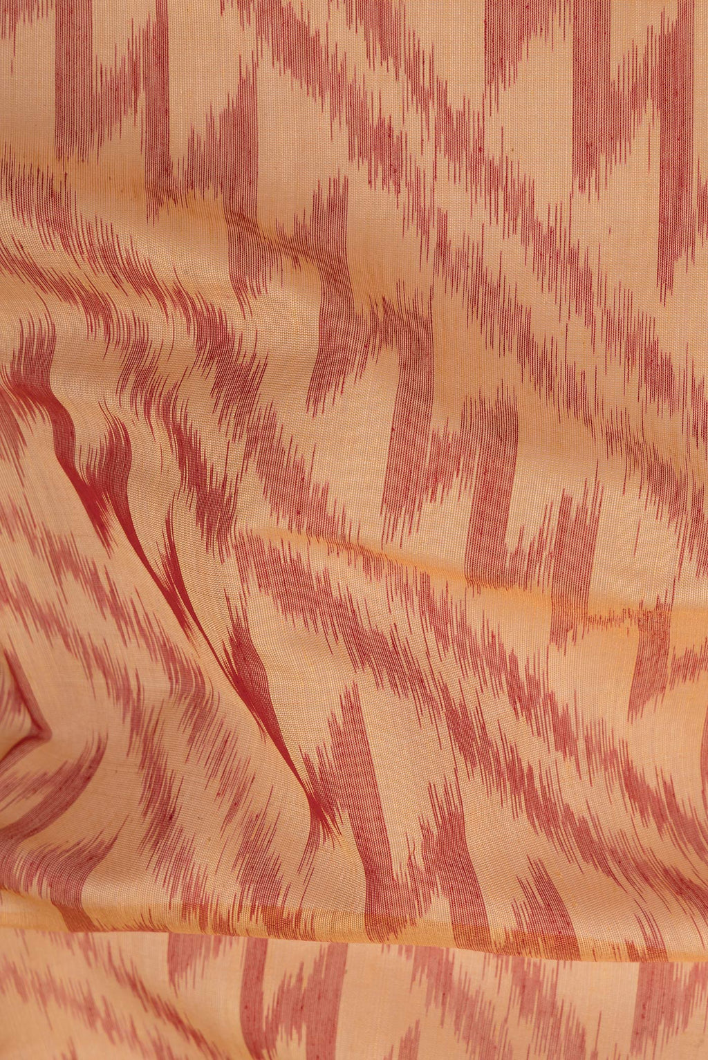 Close up of Sandal Silk Cotton Saree with Ikat Print on the body and Ikat Border.  displaying folds