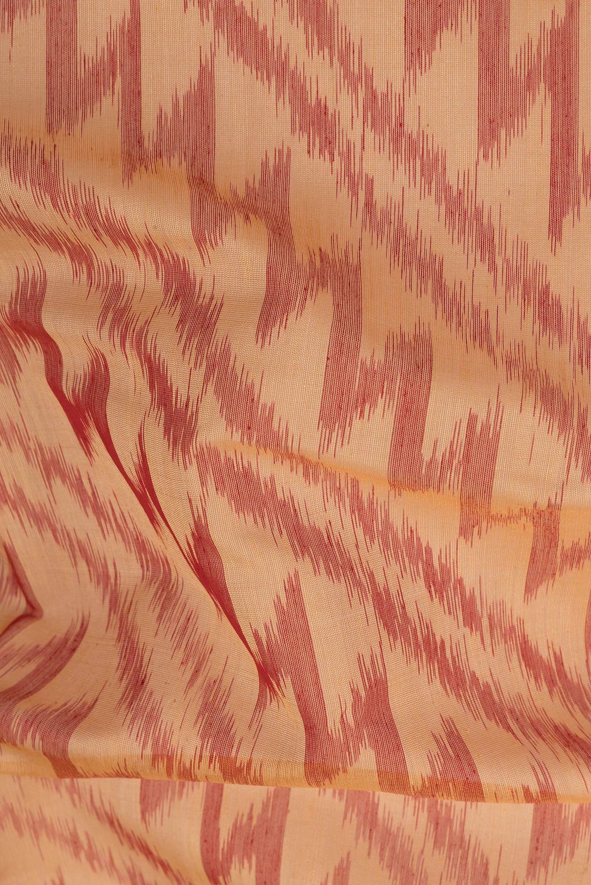 Close up of Sandal Silk Cotton Saree with Ikat Print on the body and Ikat Border.  displaying folds