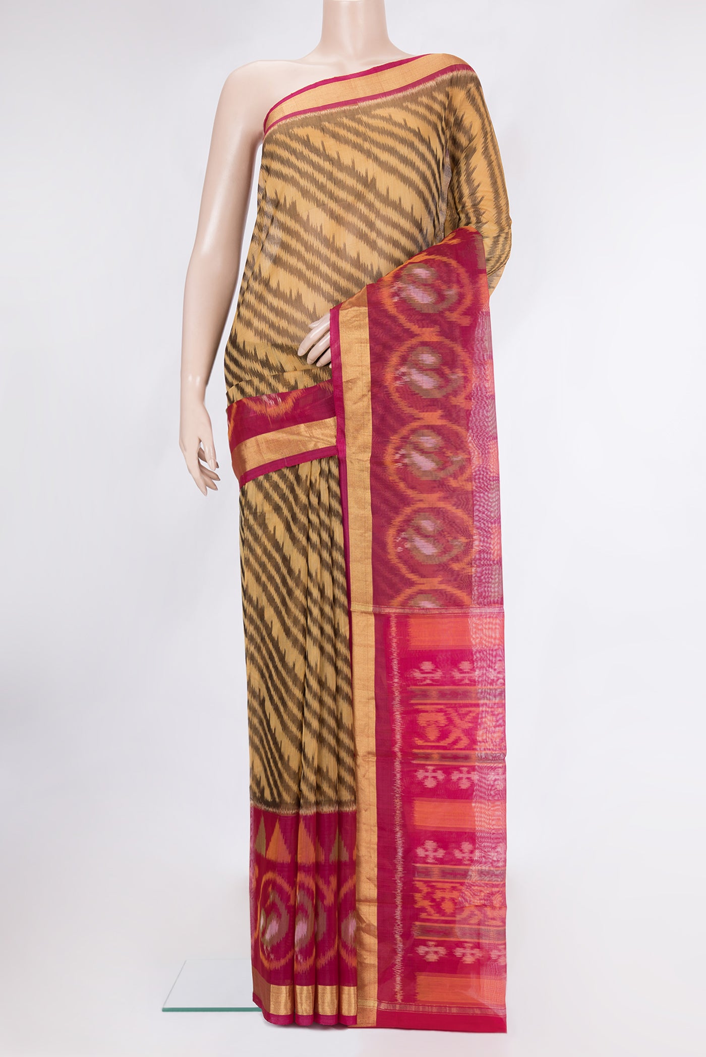 Brown Silk Cotton Saree with Ikat Print on the body and Ikat Border.  displayed on a mannequin