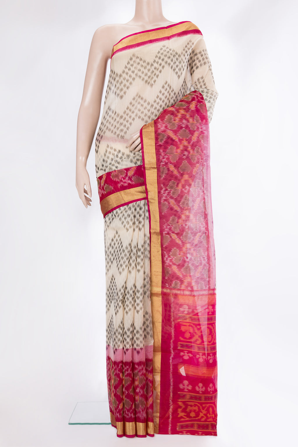 Cream Silk Cotton Saree with Ikat Print on the body and Ikat Border.  displayed on a mannequin