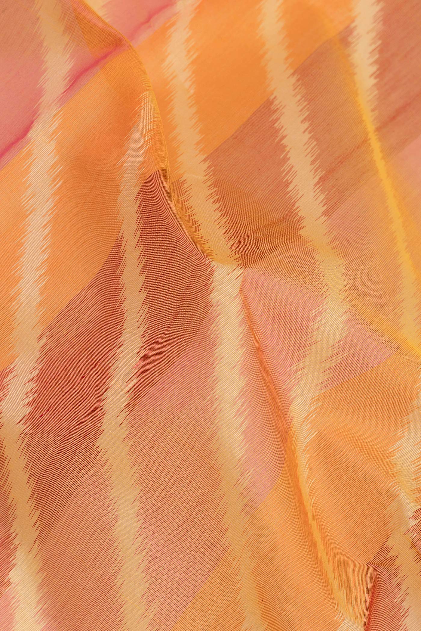 Close up of Multi Color Silk Cotton Saree with Ikat Print on the body and Zari Border.  displaying folds