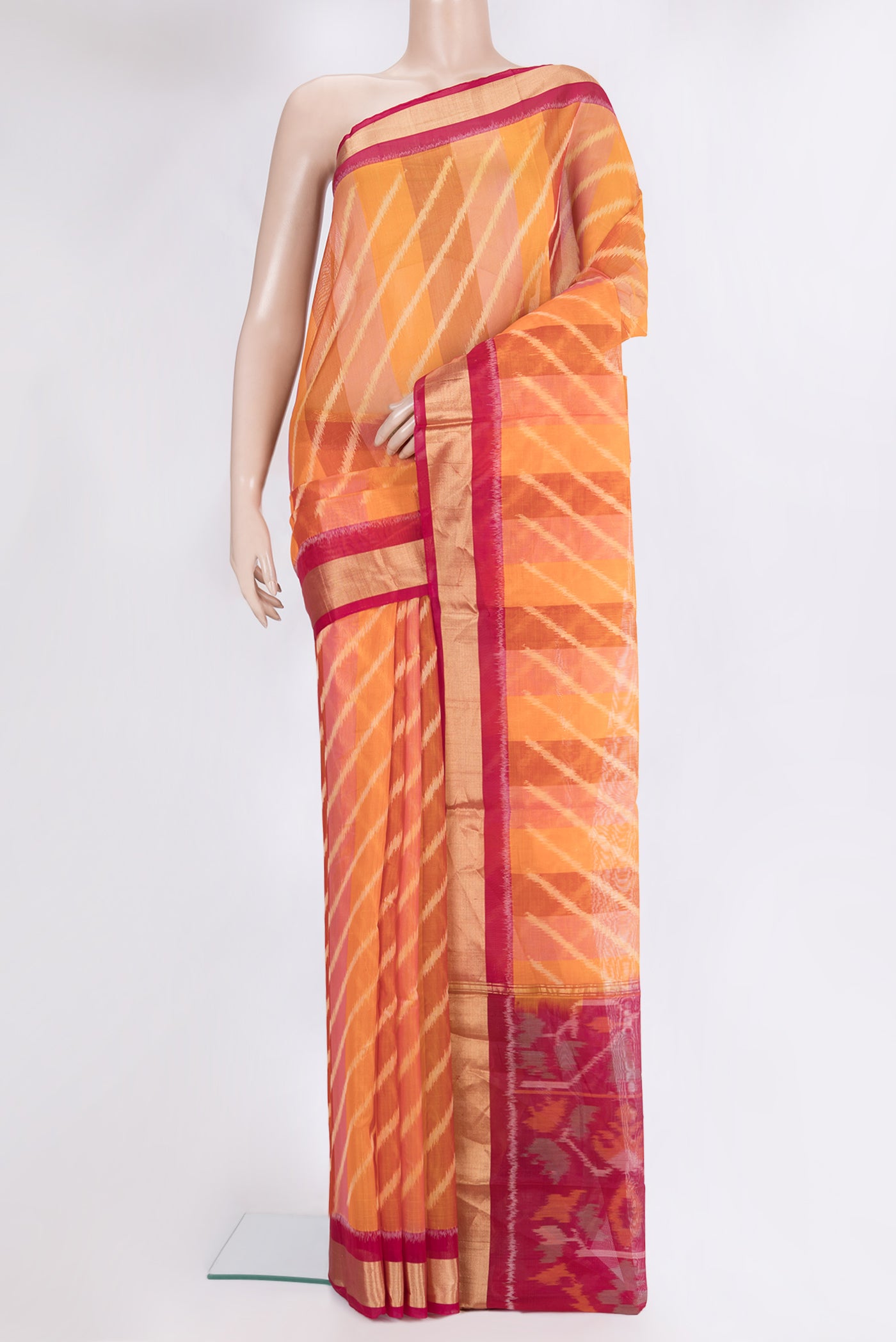 Multi Color Silk Cotton Saree with Ikat Print on the body and Zari Border.  displayed on a mannequin