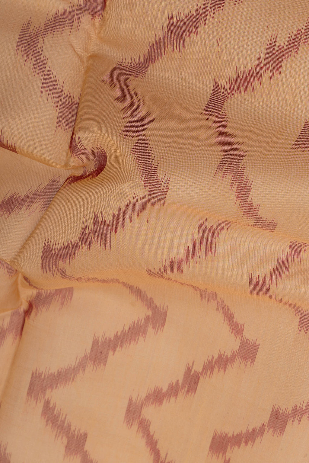 Close up of Sandal Silk Cotton Saree with Ikat Print on the body and Zari Border.  displaying folds