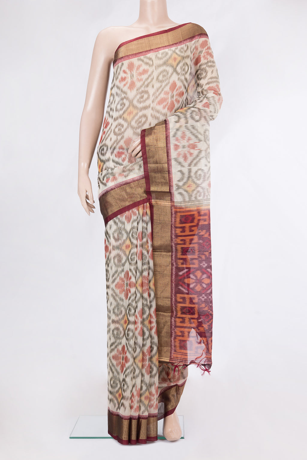 White Silk Cotton Saree with Ikat Print on the body and Zari Border.  displayed on a mannequin
