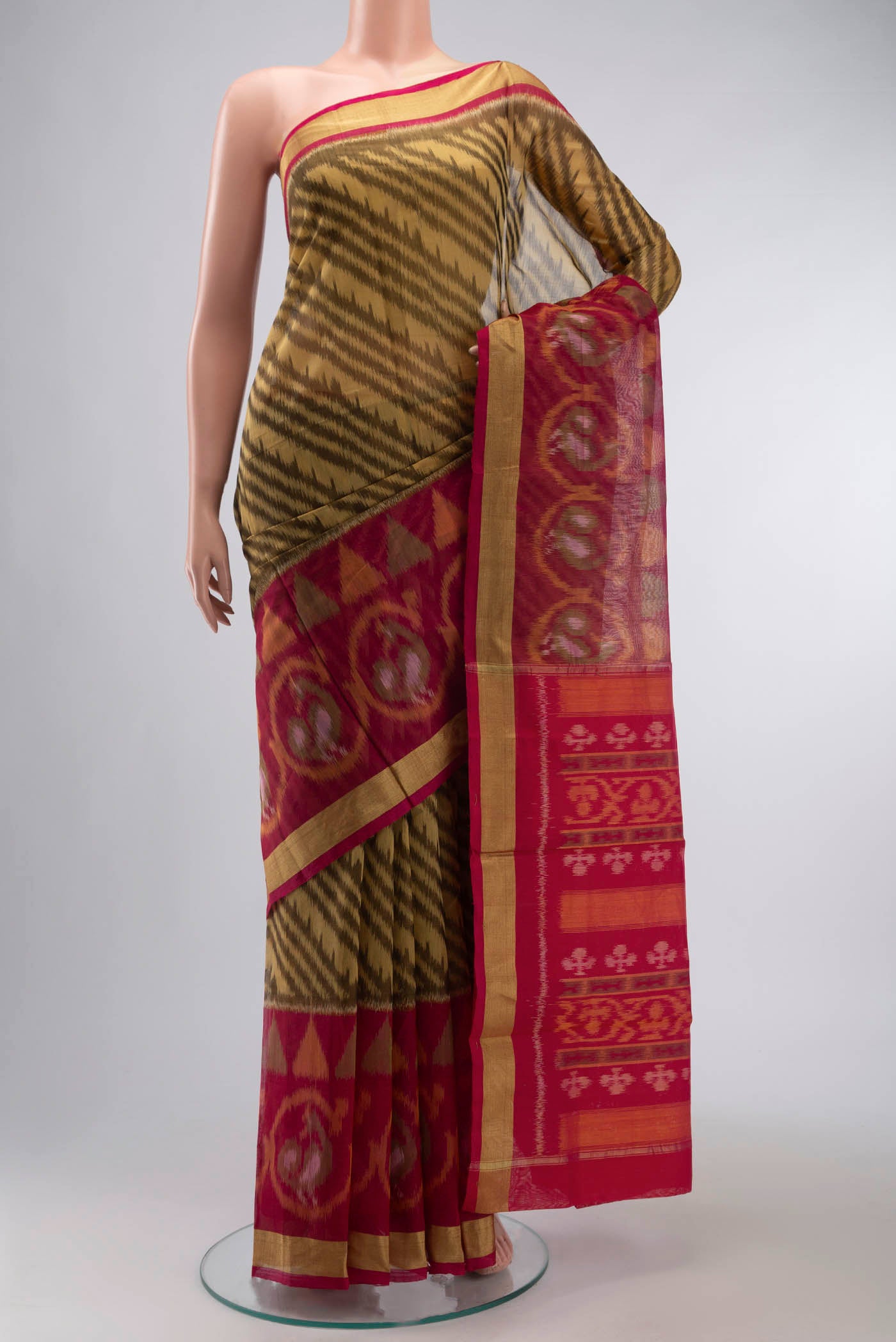 Brown Silk Cotton Saree with Ikat Print on the body and Zari Border displayed on a mannequin