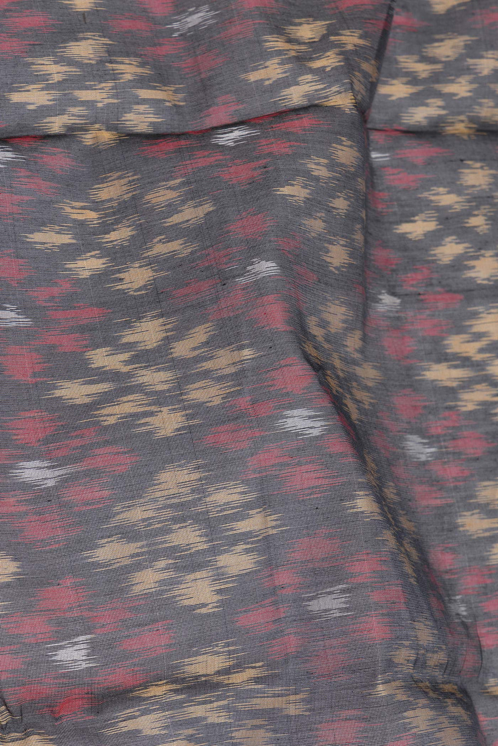 Close up of Black Silk Cotton Saree with Ikat Print on the body and Zari Border.  displaying folds