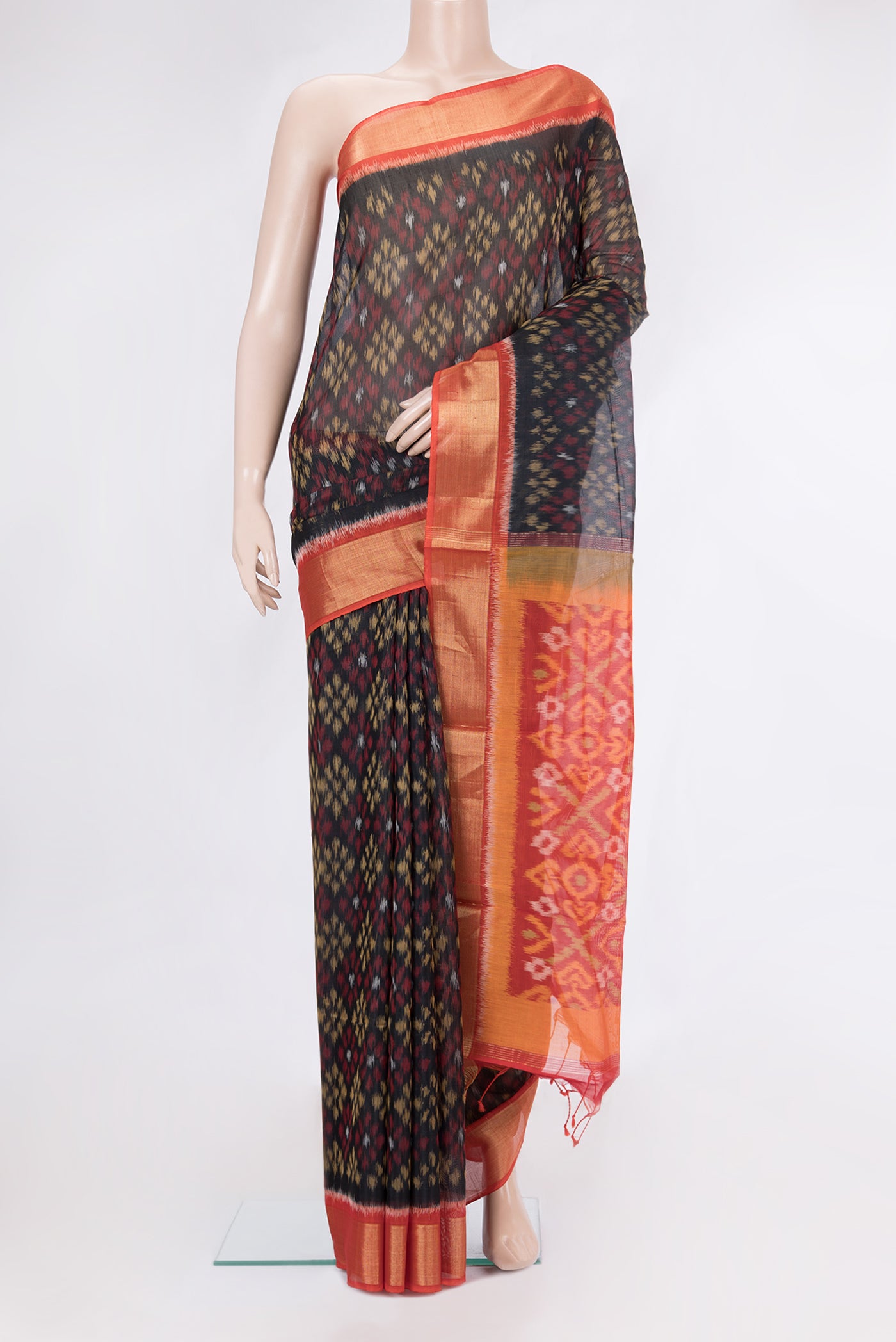 Black Silk Cotton Saree with Ikat Print on the body and Zari Border.  displayed on a mannequin