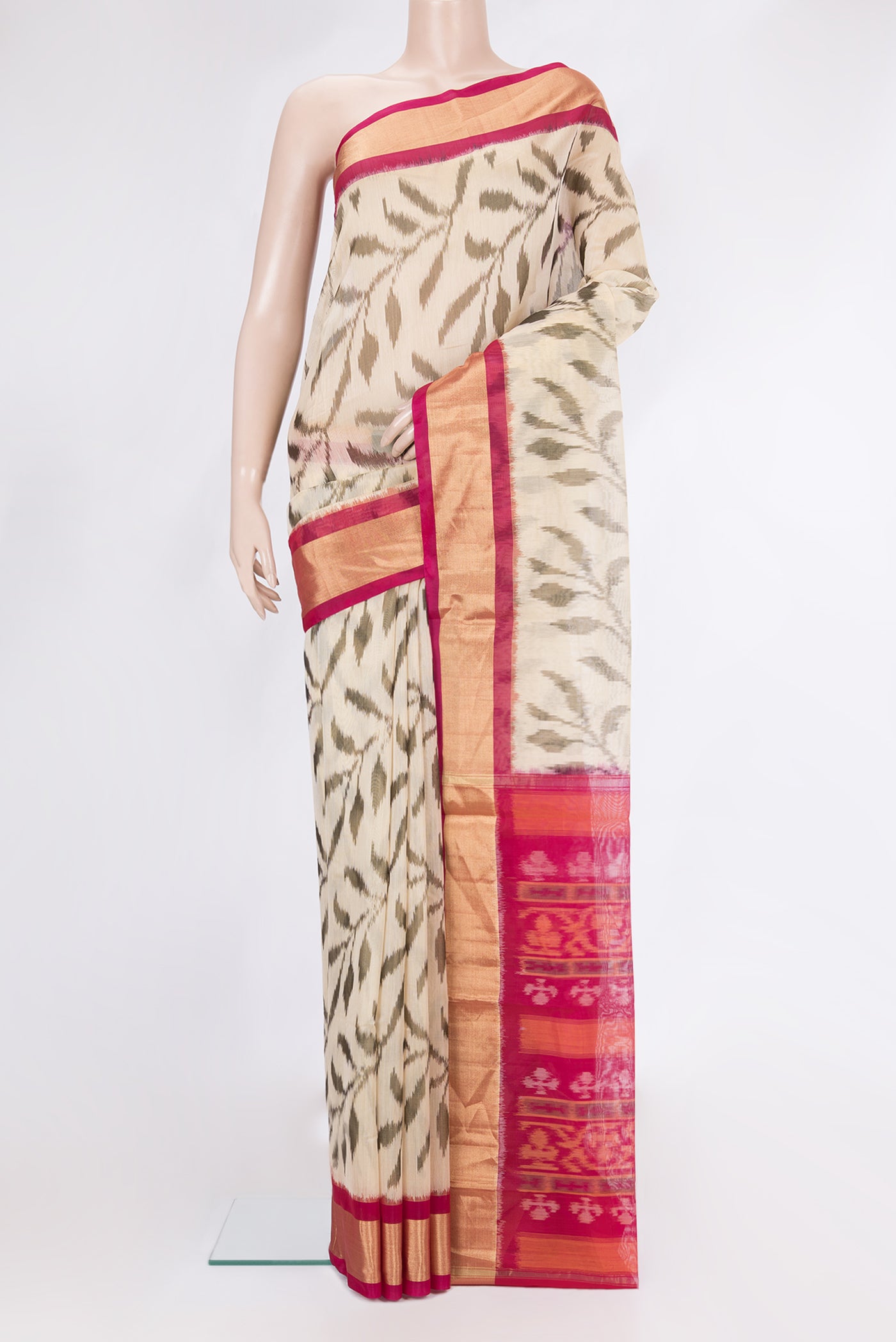 Beige Silk Cotton Saree with Ikat Print on the body and Zari Border.  displayed on a mannequin