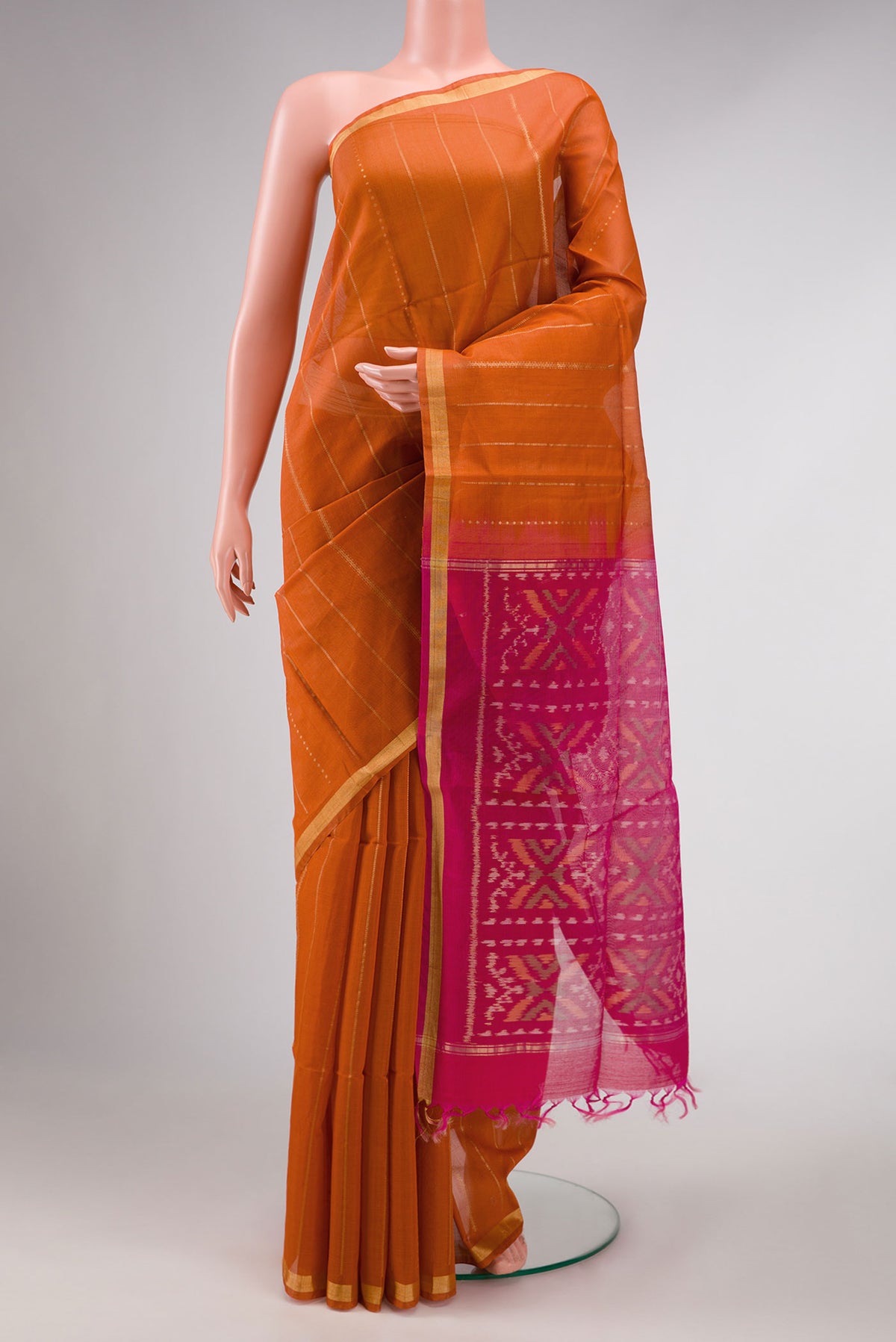 Orange Dual Tone Silk Cotton Saree with Stripes on the body and Zari Border displayed on a mannequin
