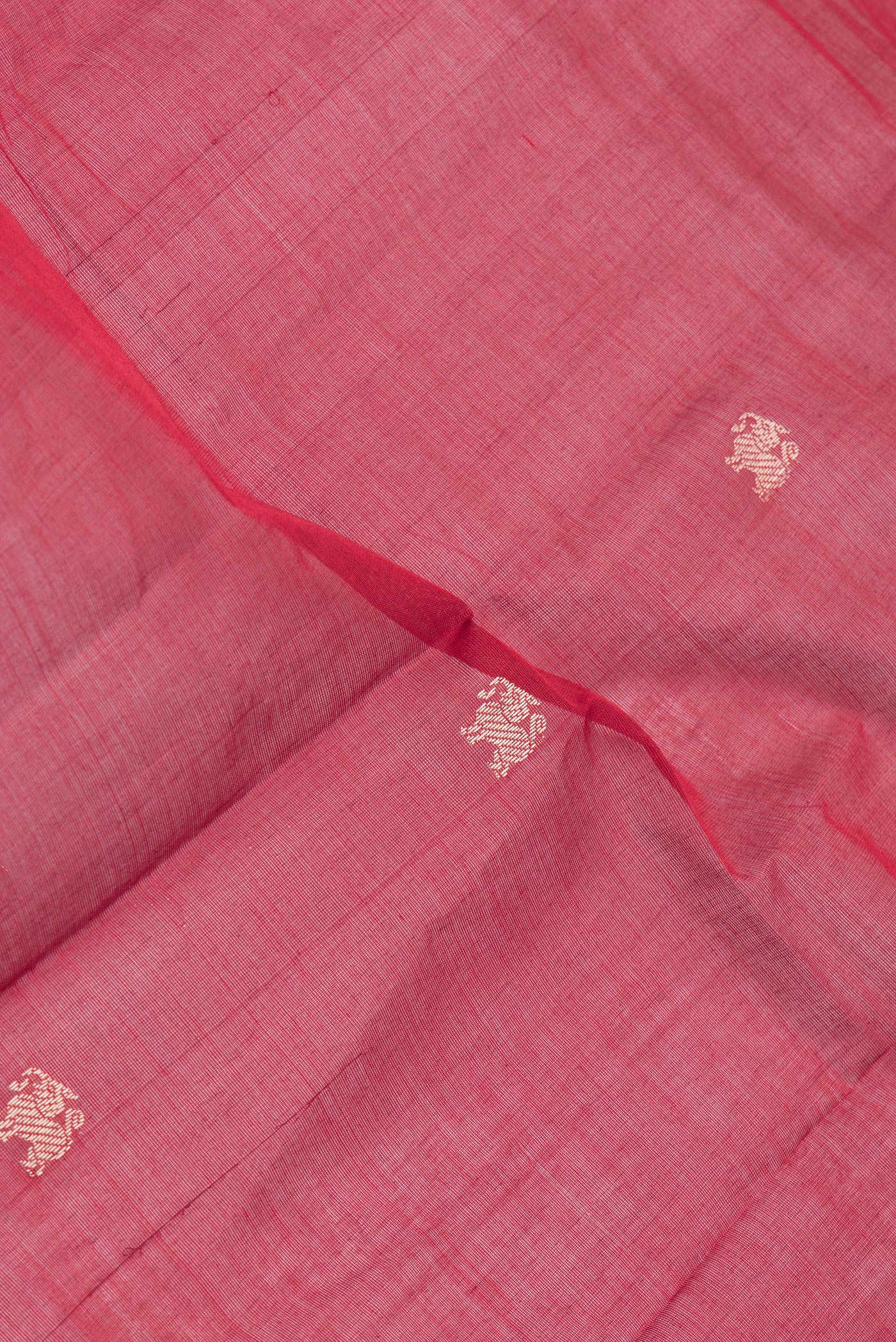 Close up of Maroon Kanchi Cotton Saree with Thread Butta on the body and Thread Border.  displaying folds