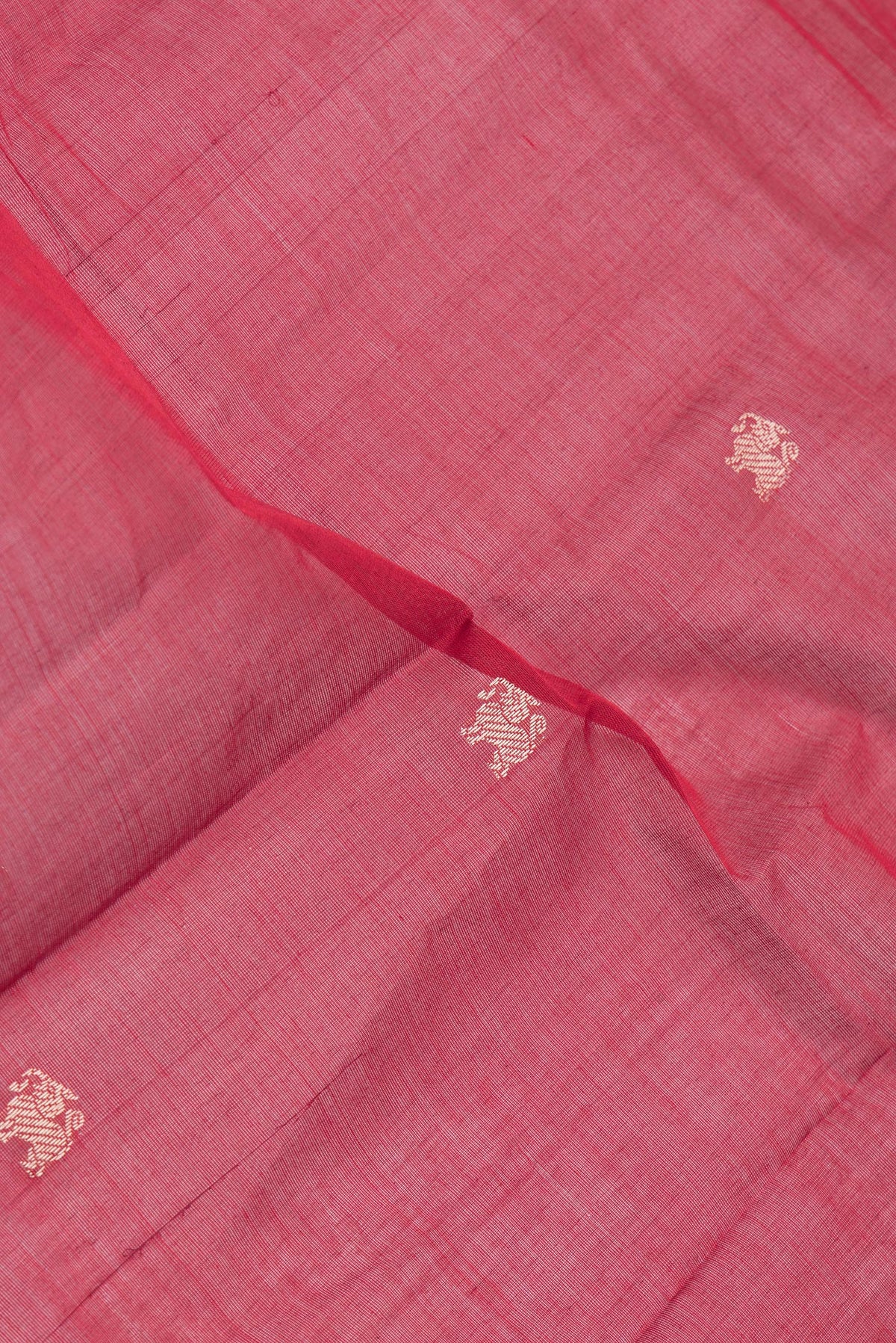Close up of Maroon Kanchi Cotton Saree with Thread Butta on the body and Thread Border.  displaying folds