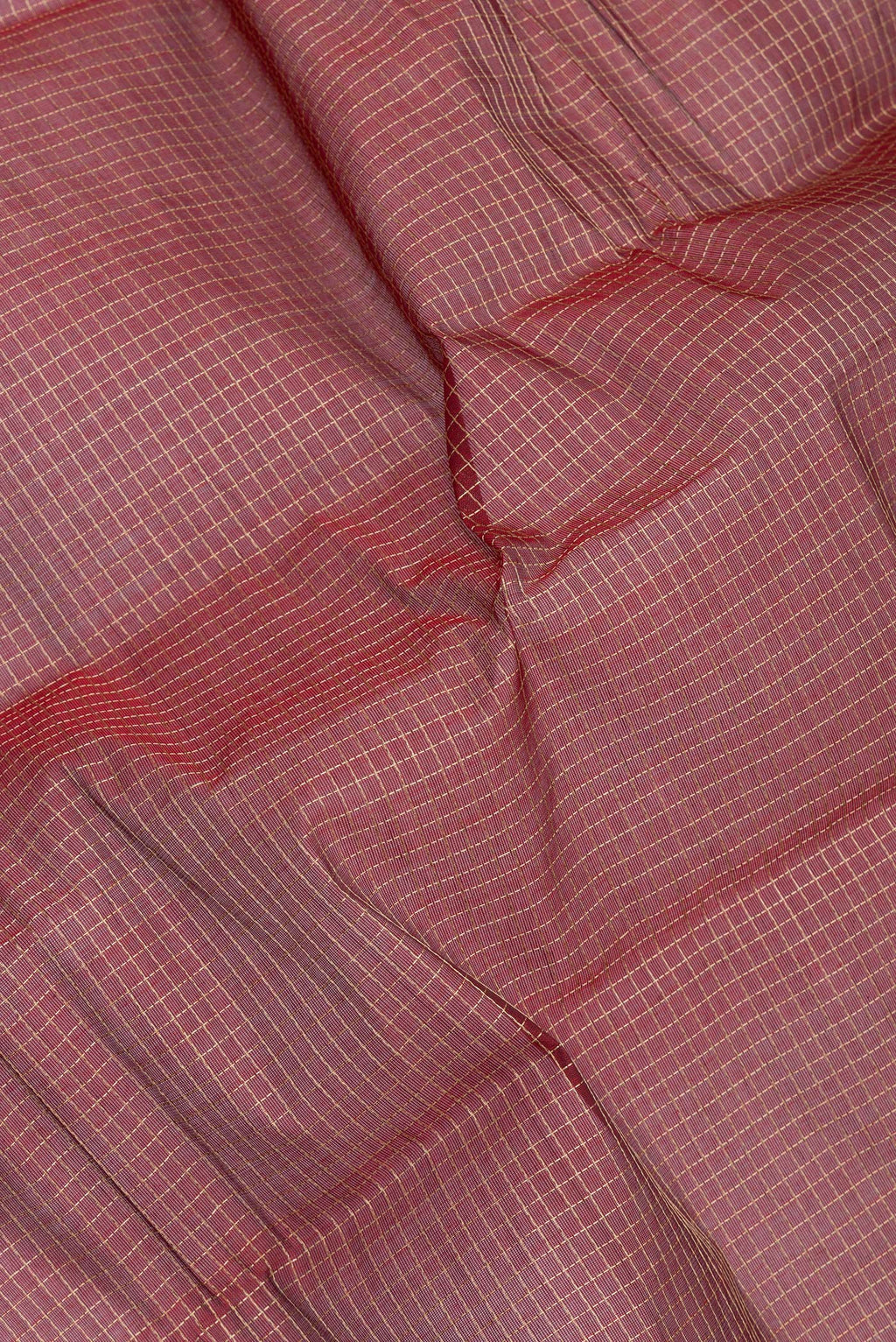 Close up of Maroon Kanchi Cotton Saree with Checked design on the body and Thread Border.  displaying folds