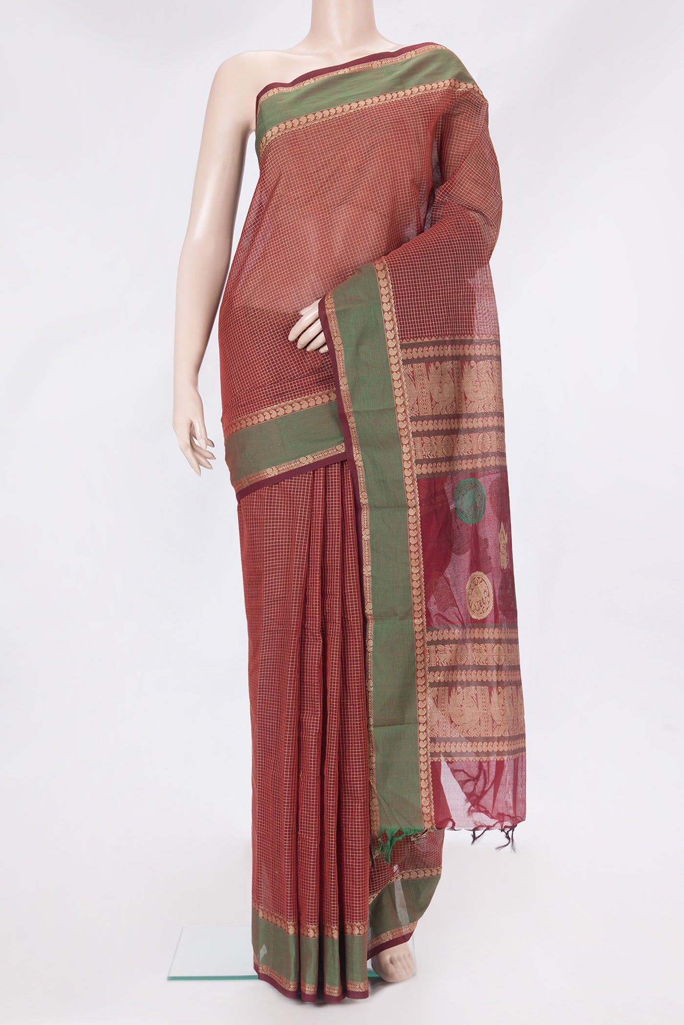 Maroon Kanchi Cotton Saree with Checked design on the body and Thread Border.  displayed on a mannequin