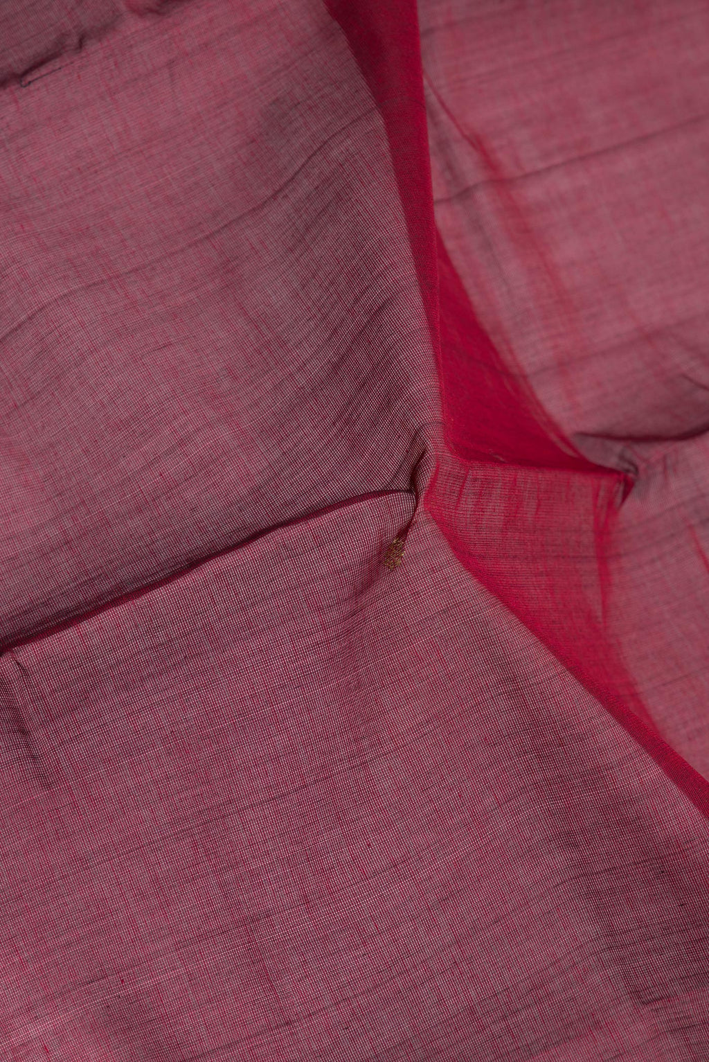 Close up of Maroon Kanchi Cotton Saree with Zari Butta on the body and Zari Border.  displaying folds