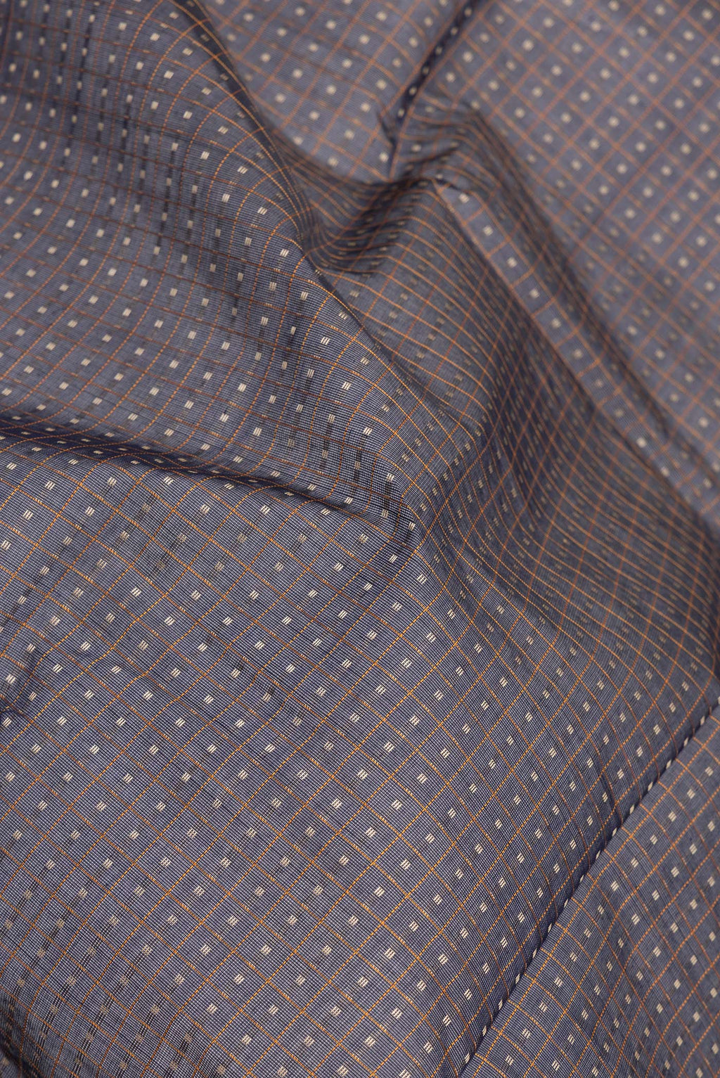 Close up of Navy Blue Kanchi Cotton Saree with Checked design on the body and Zari Border.  displaying folds