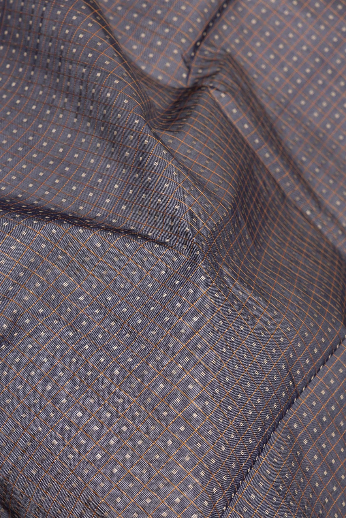 Close up of Navy Blue Kanchi Cotton Saree with Checked design on the body and Zari Border.  displaying folds