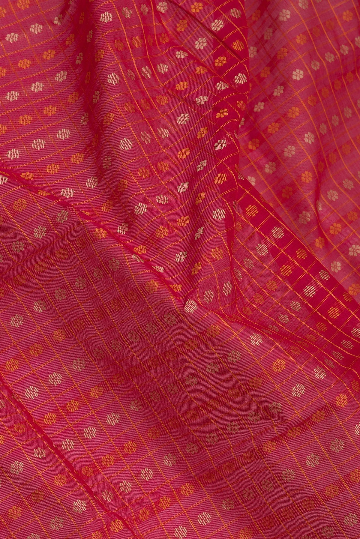 Close up of Dark Pink Dual Tone Kanchi Cotton Saree with Thread Butta on the body and Zari And Thread Border.  displaying folds