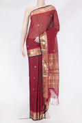 Maroon Silk Cotton Saree with Zari Butta on the body and Zari Border.  displayed on a mannequin