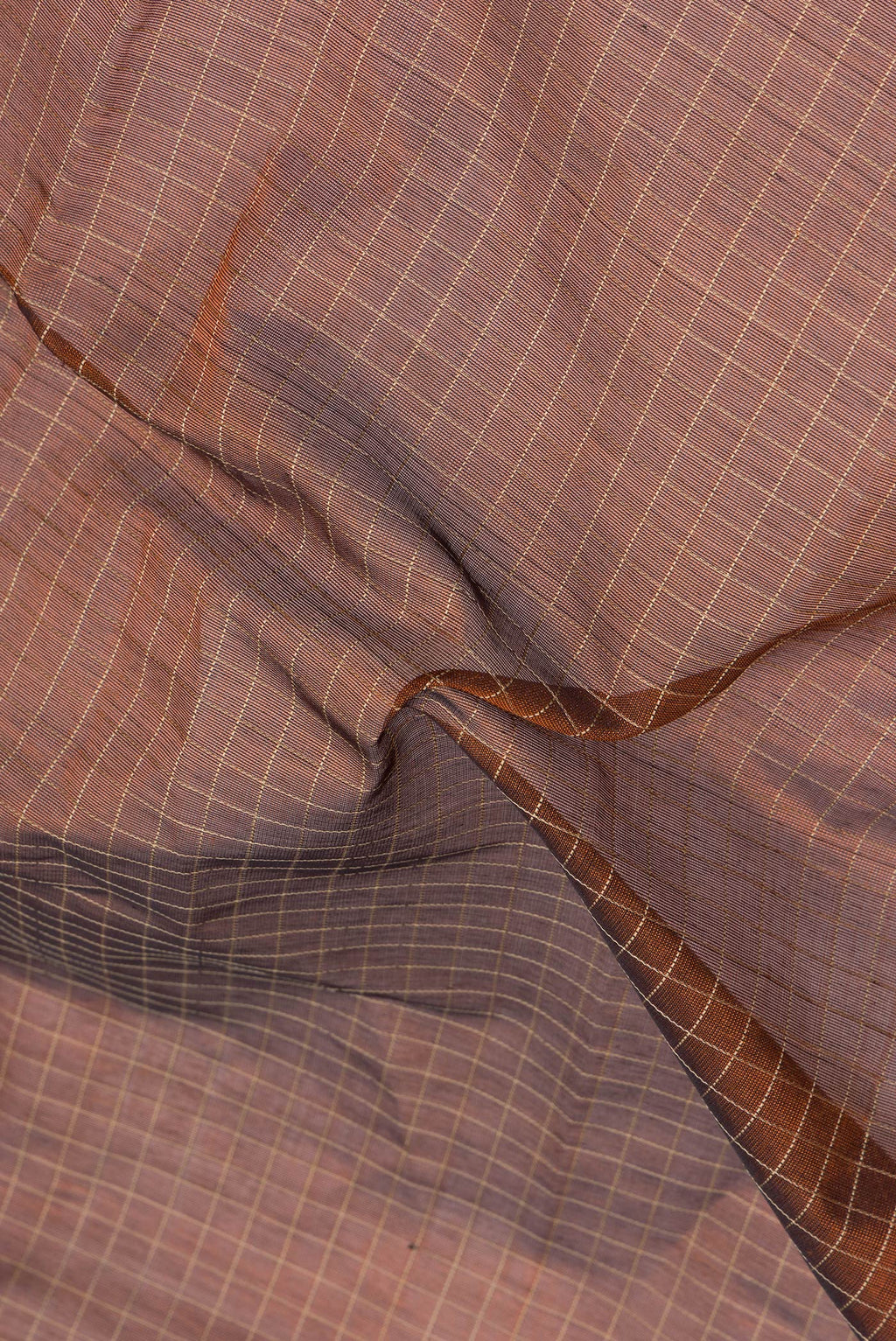 Close up of Brown Silk Cotton Saree with Checked design on the body and Zari Border.  displaying folds