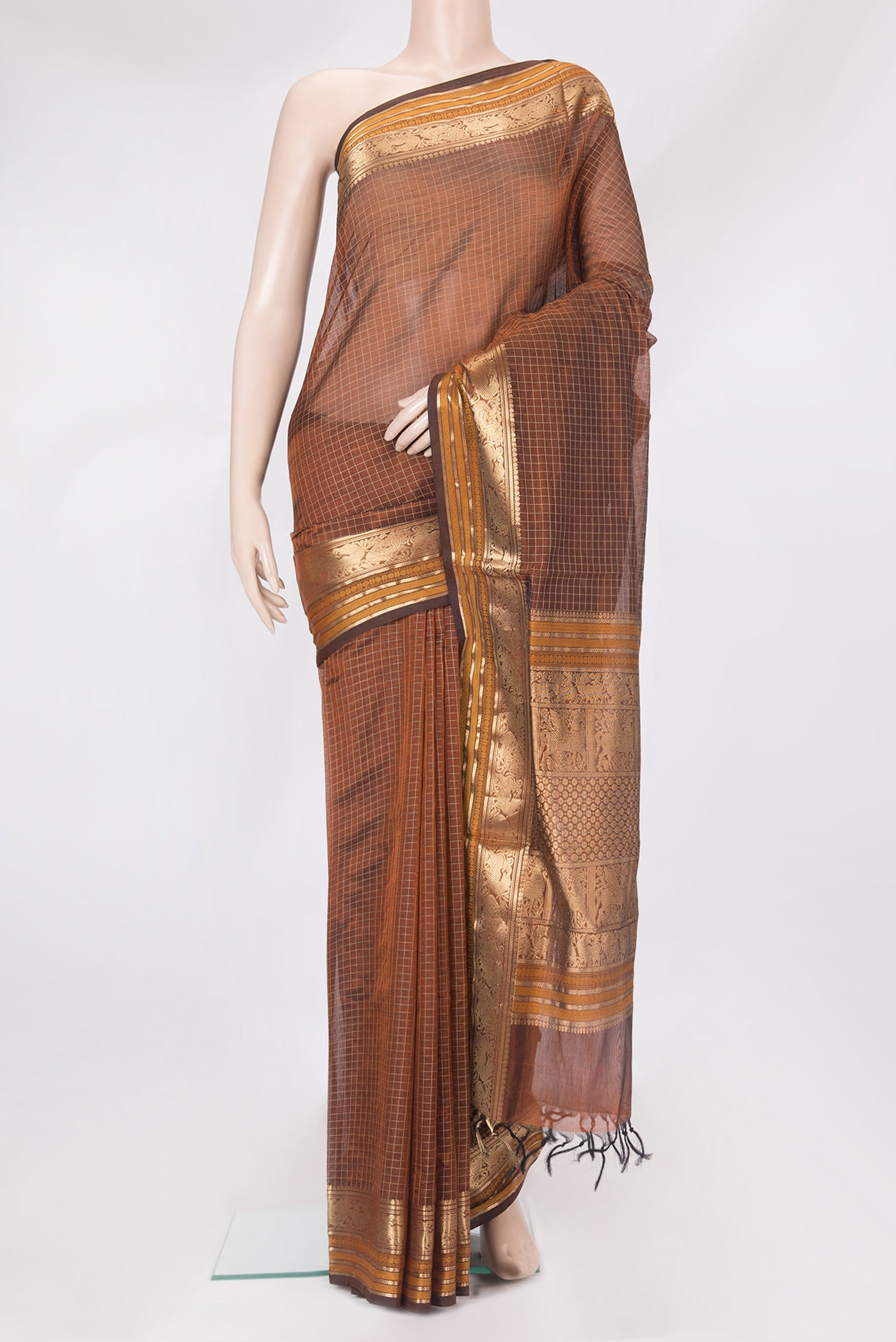 Brown Silk Cotton Saree with Checked design on the body and Zari Border.  displayed on a mannequin