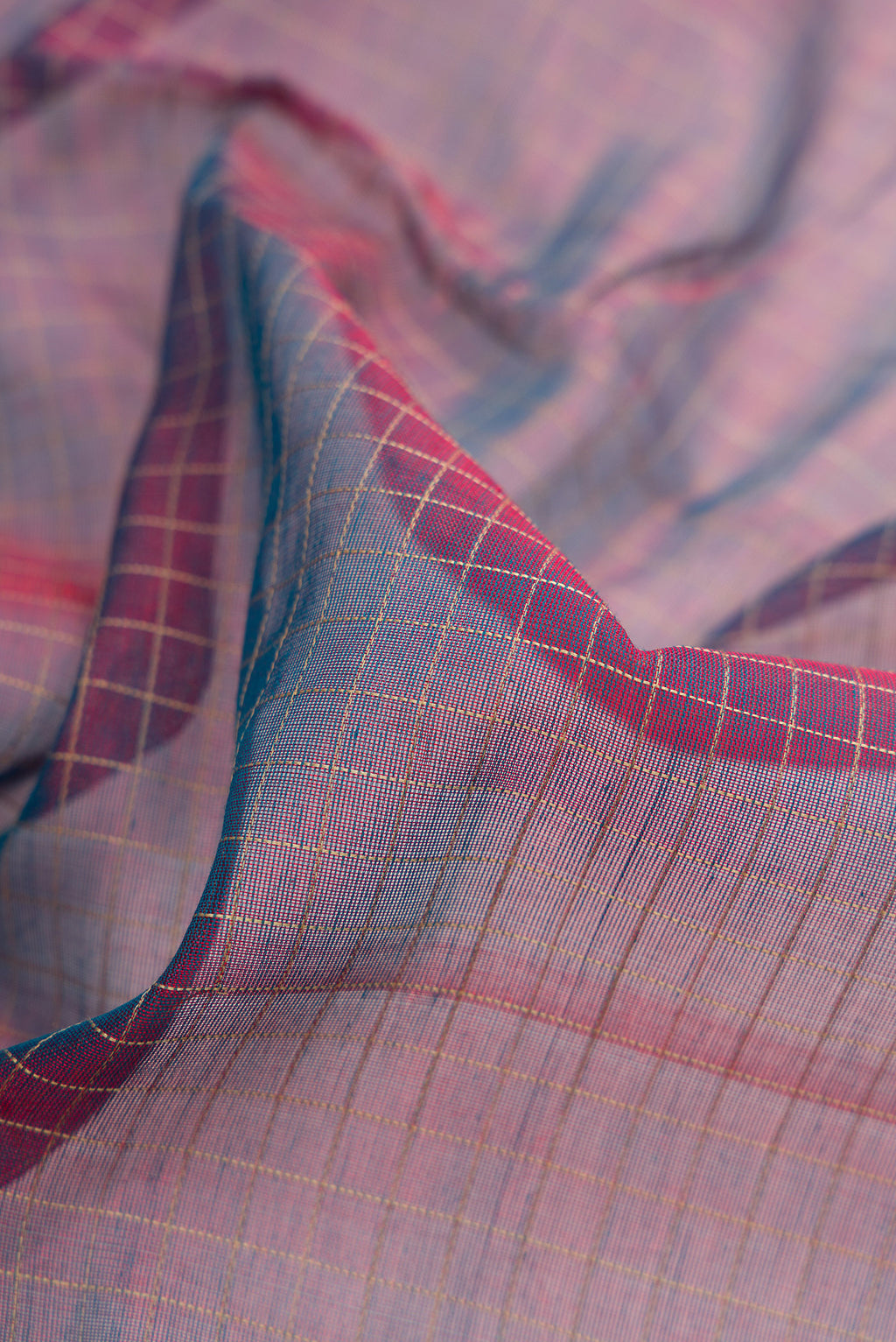 Close up of Peacock Blue Dual Tone Silk Cotton Saree with Checked design on the body and Zari Border.  displaying folds