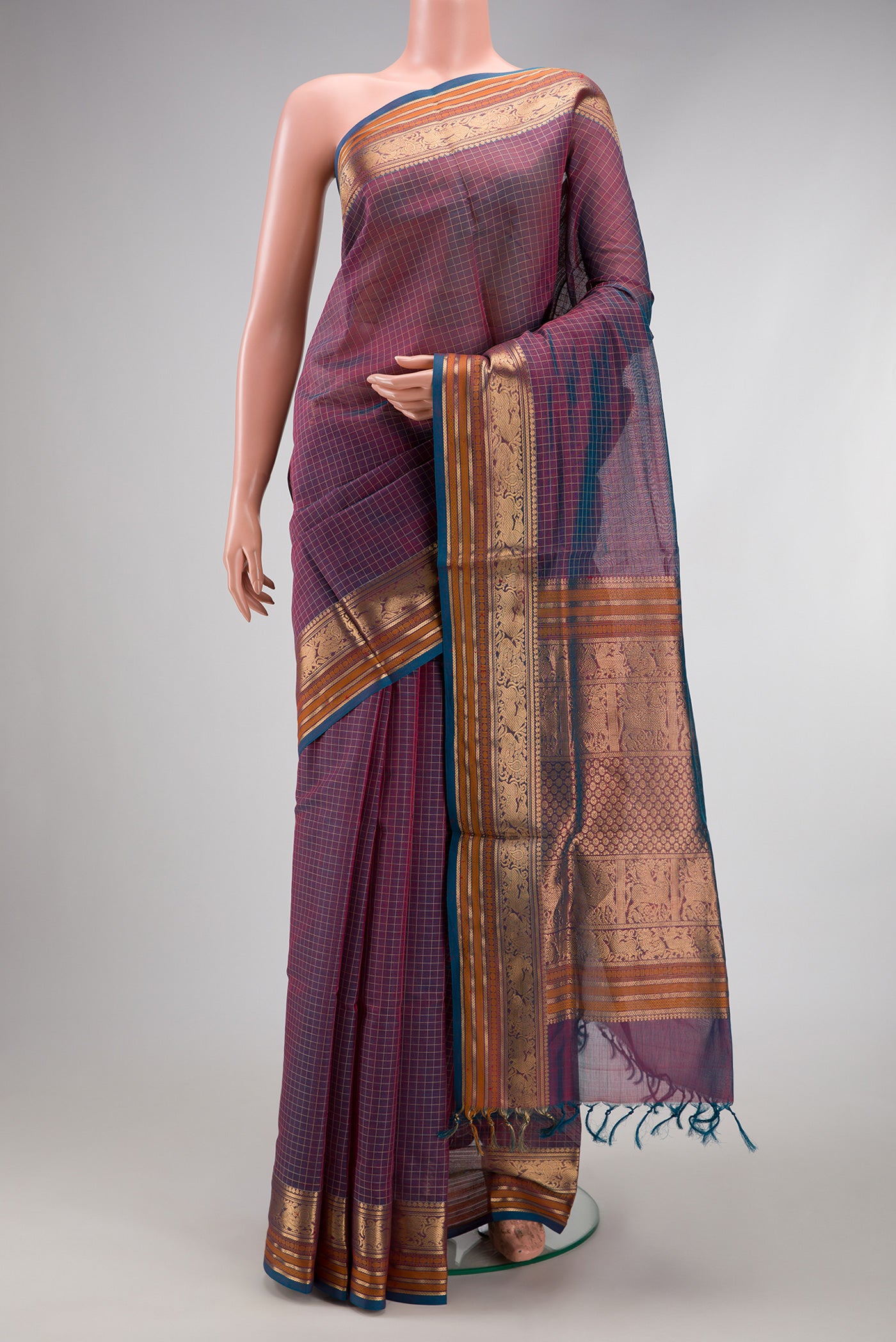 Peacock Blue Dual Tone Silk Cotton Saree with Checked design on the body and Zari Border.  displayed on a mannequin