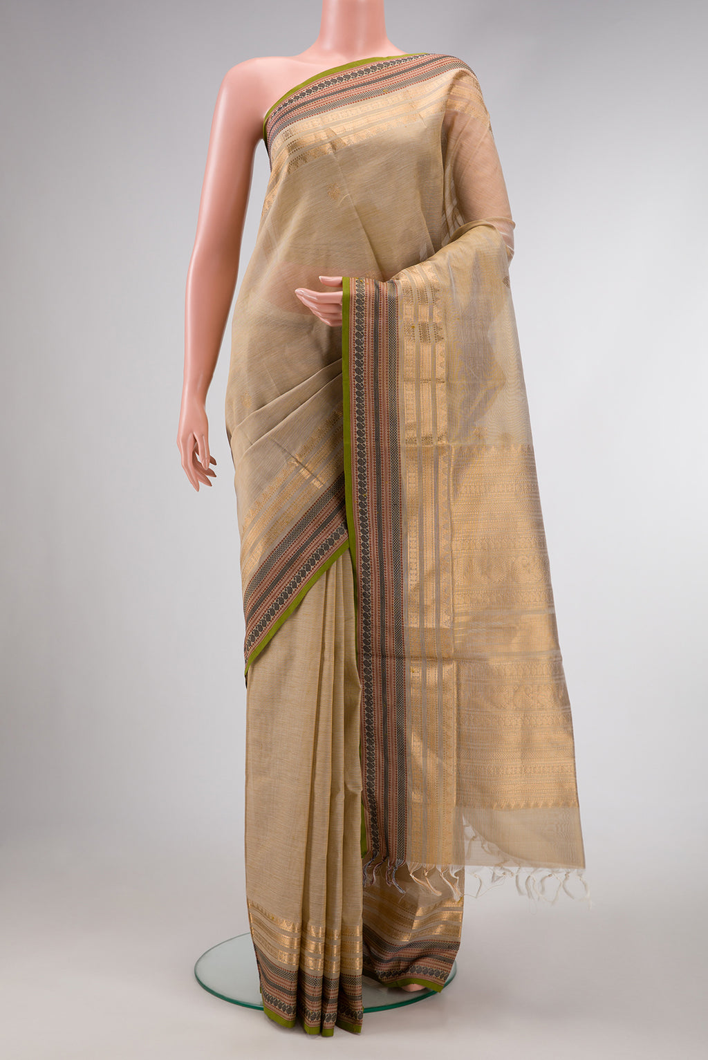 Beige Dual Tone Silk Cotton Saree with Zari Butta on the body and Zari Border.  displayed on a mannequin