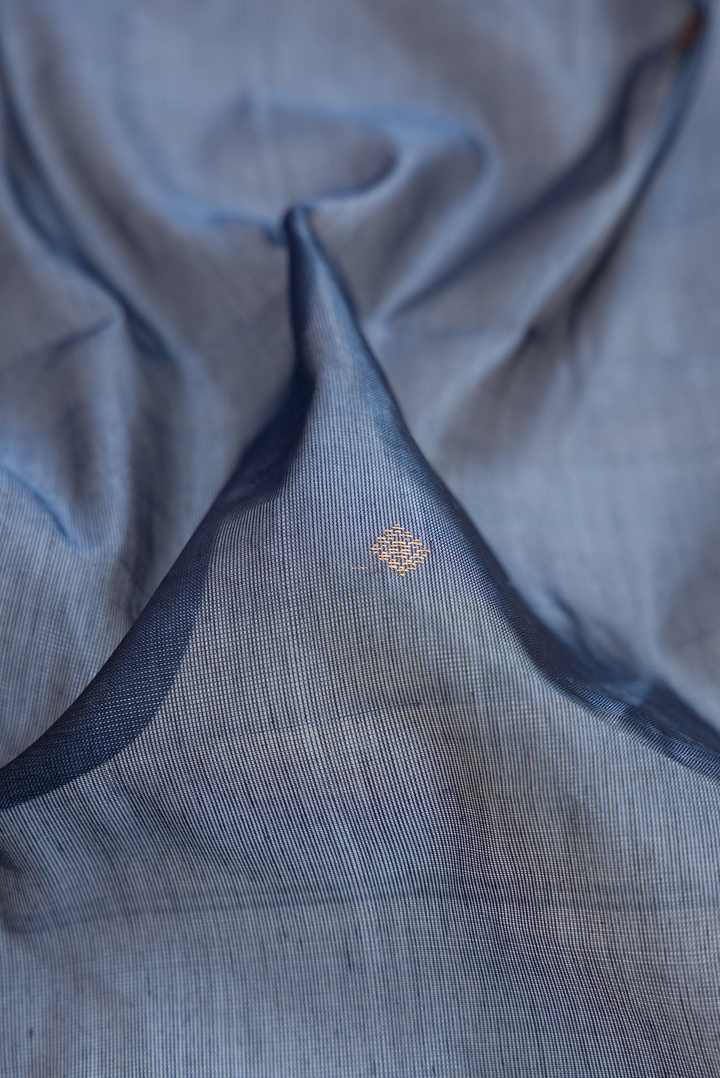 Close up of Blue Grey Dual Tone Silk Cotton Saree with Zari Butta on the body and Fancy Border.  displaying folds