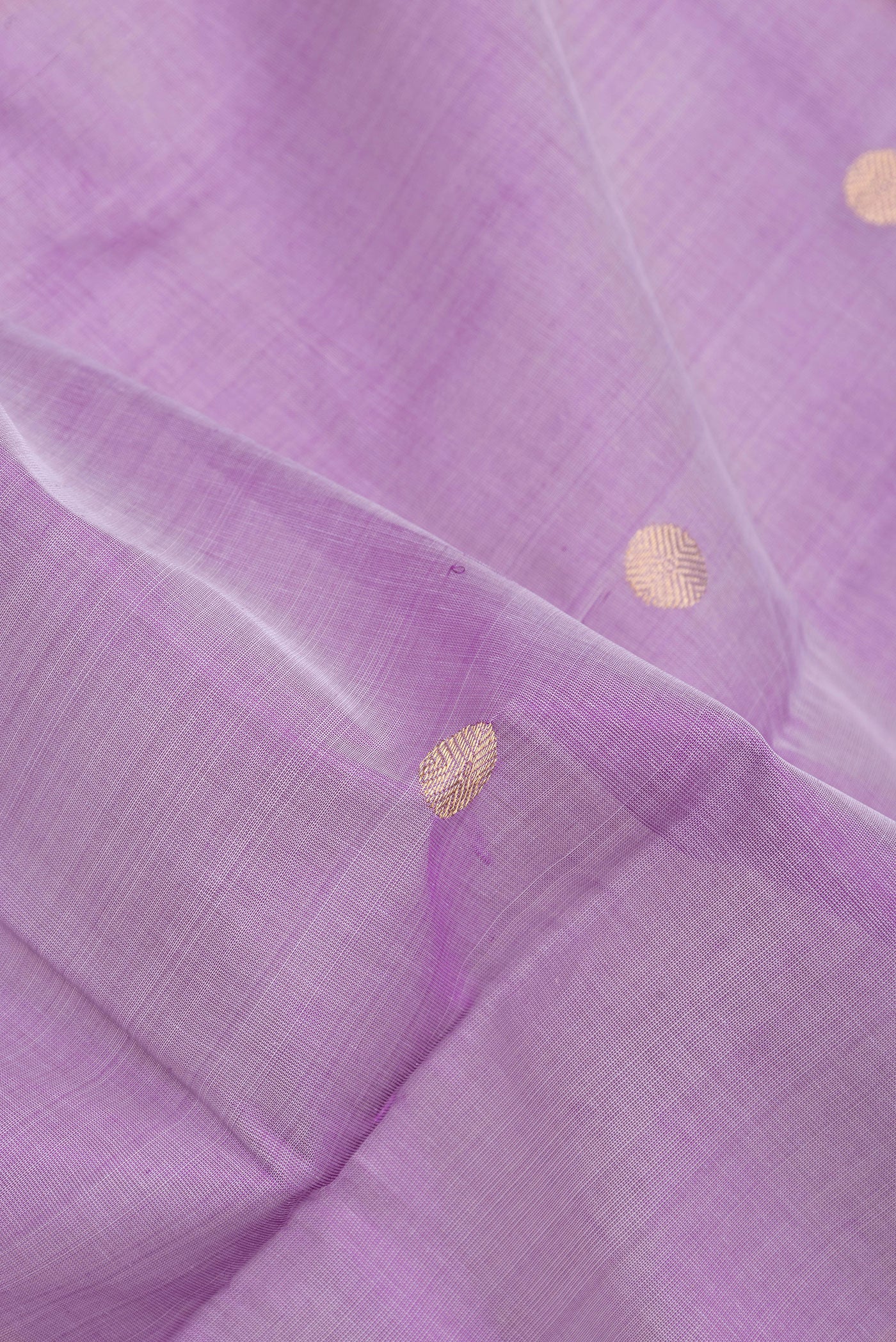 Close up of Lavender Silk Cotton Saree with Zari Butta on the body and Zari Border.  displaying folds