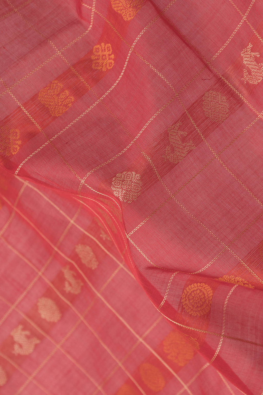 Close up of Red Silk Cotton Saree with Checked design on the body and Zari Border.  displaying folds