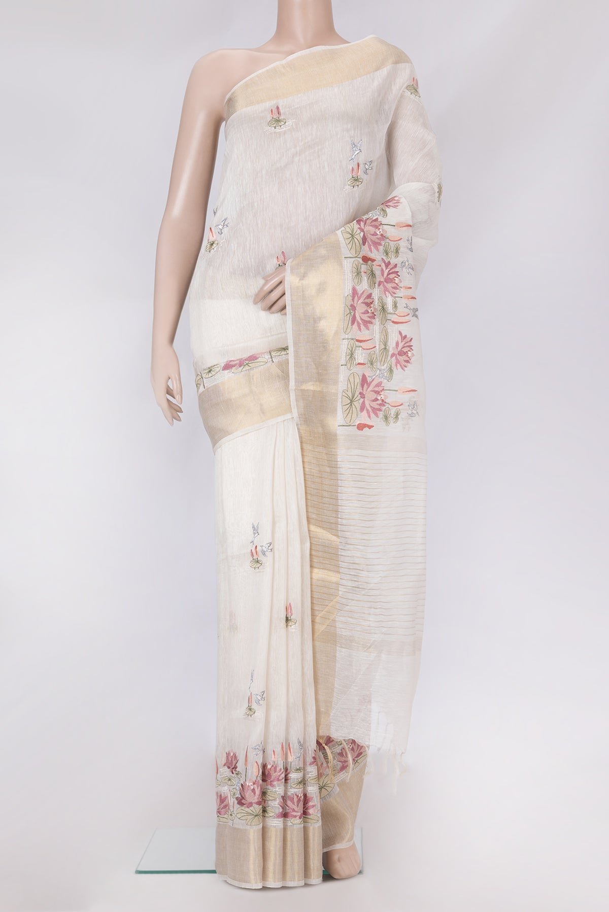 Off White Linen Saree with Embroidery on the body and Zari Border.  displayed on a mannequin