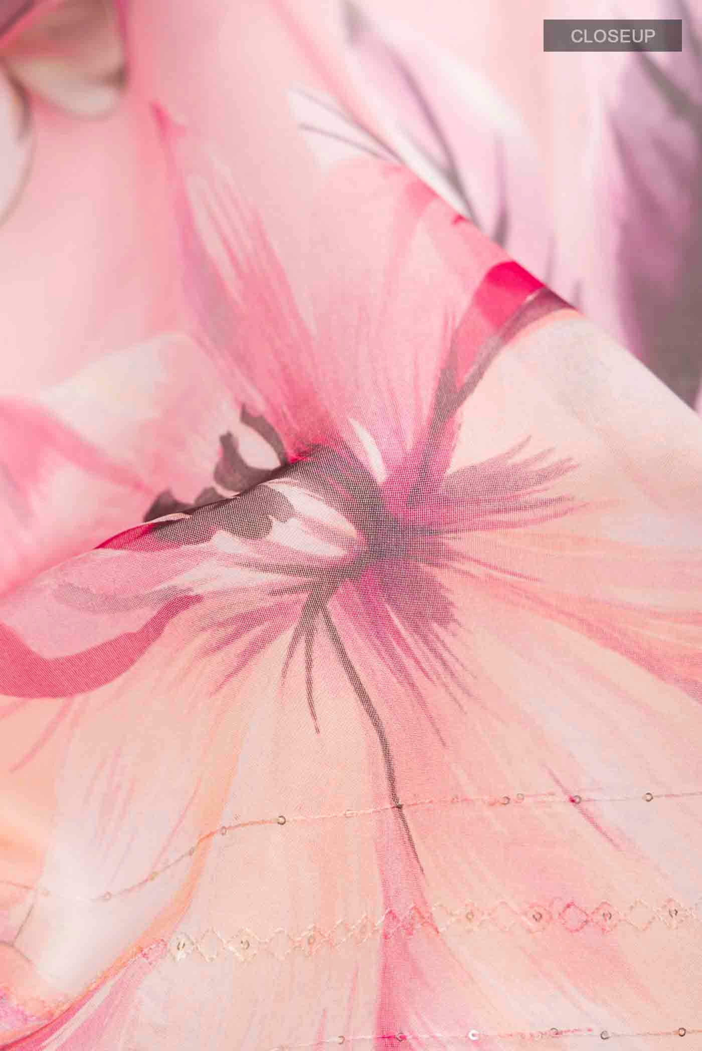 Close up of Pink Organza Silk Saree with Printed design on the body and Without Border displaying folds