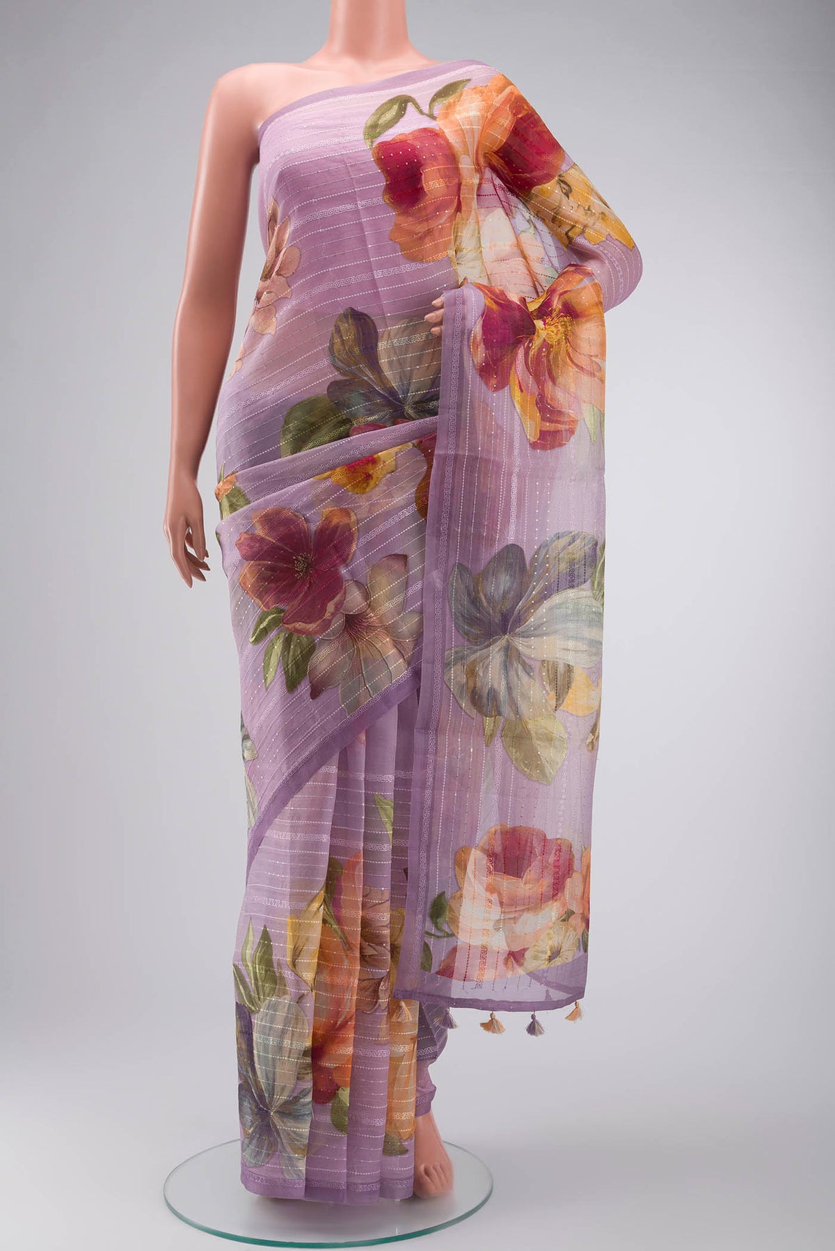 Lavender Organza Silk Saree with Printed design on the body and Embroidery Border displayed on a mannequin