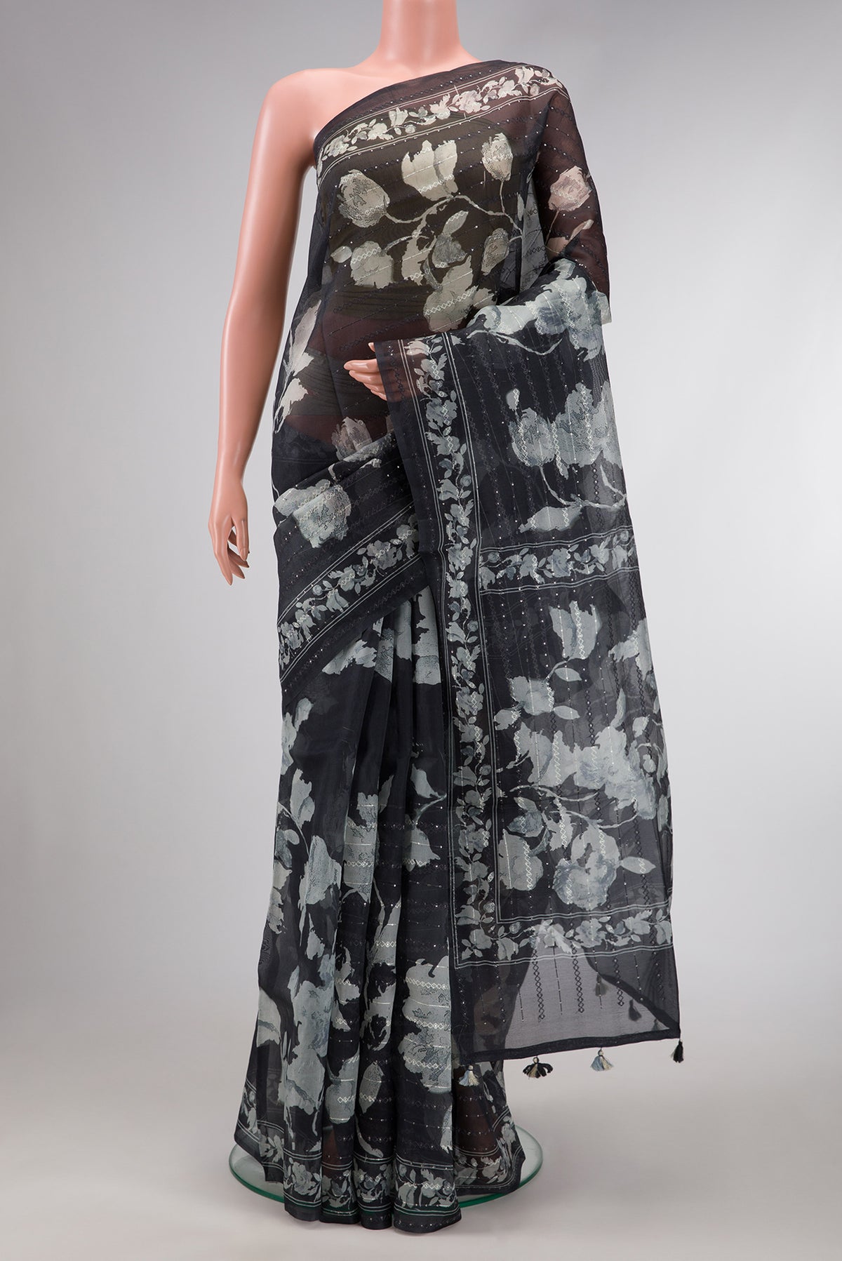 Black Dual Tone Organza Silk Saree with Printed design on the body and Printed Border.  displayed on a mannequin