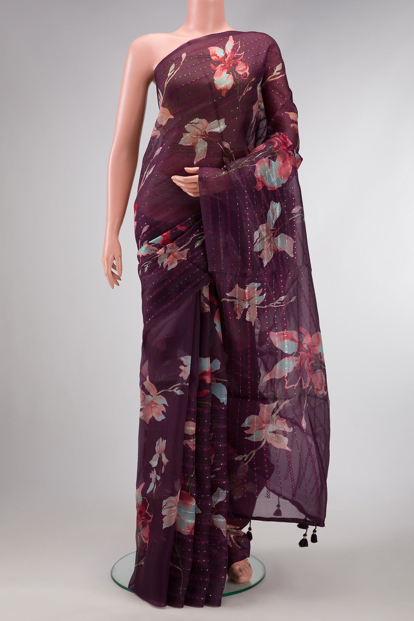 Burgundy Dual Tone Organza Silk Saree with Printed design on the body and Without Border.  displayed on a mannequin