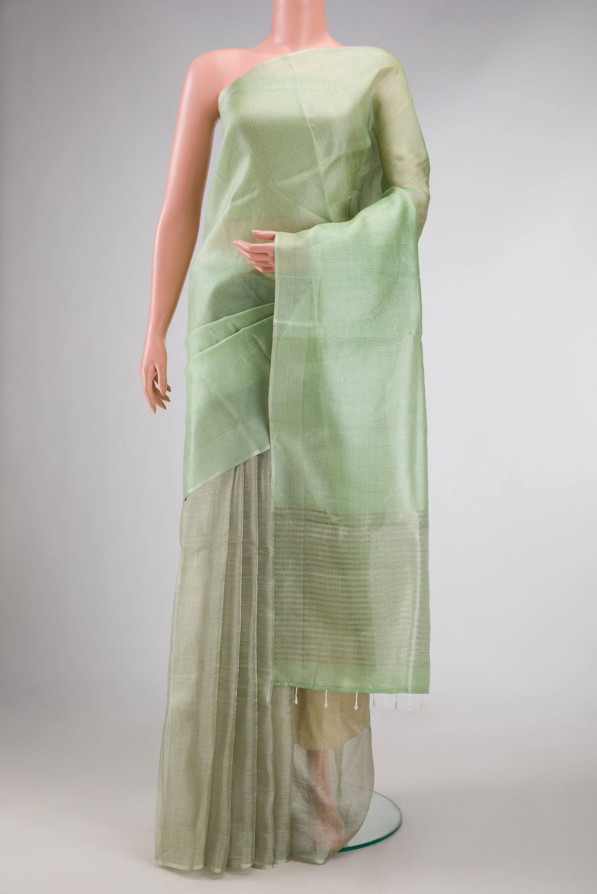 Pista Green Dual Tone Tussar Silk Saree with Plain Body and Zari Border displayed on a mannequin