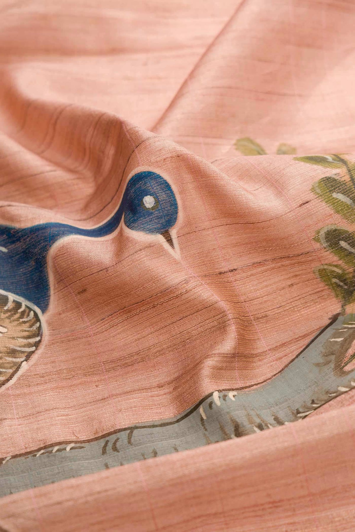 Close up of Rose Gold Dual Tone Tussar Silk Saree with Checked design on the body and Zari Border displaying folds