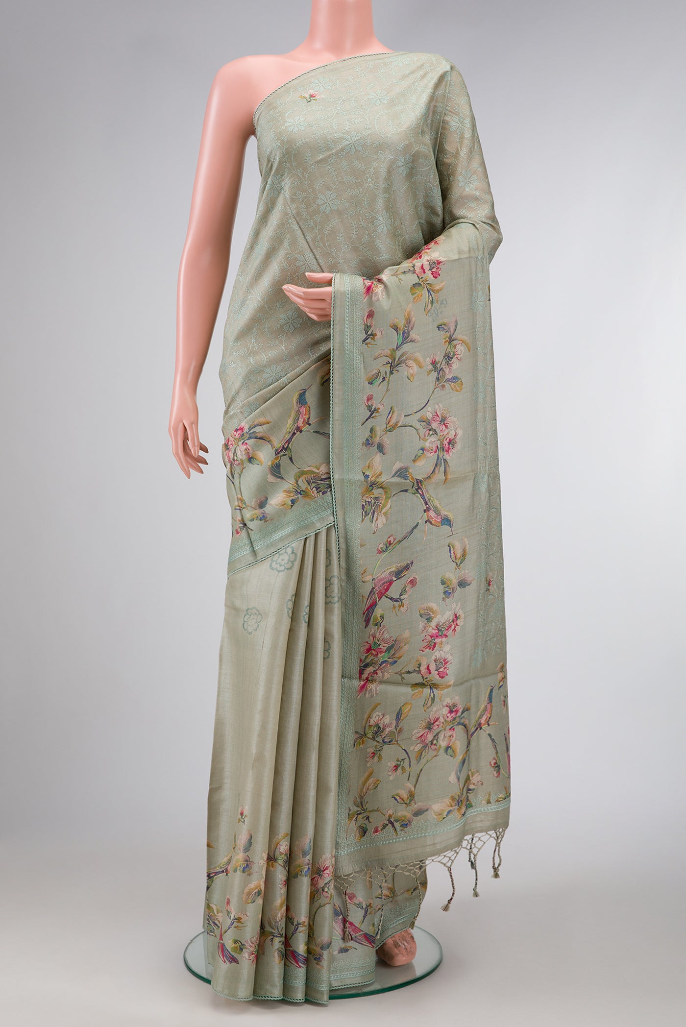 Grey Dual Tone Tussar Silk Saree with Printed design on the body and Embroidery Border.  displayed on a mannequin