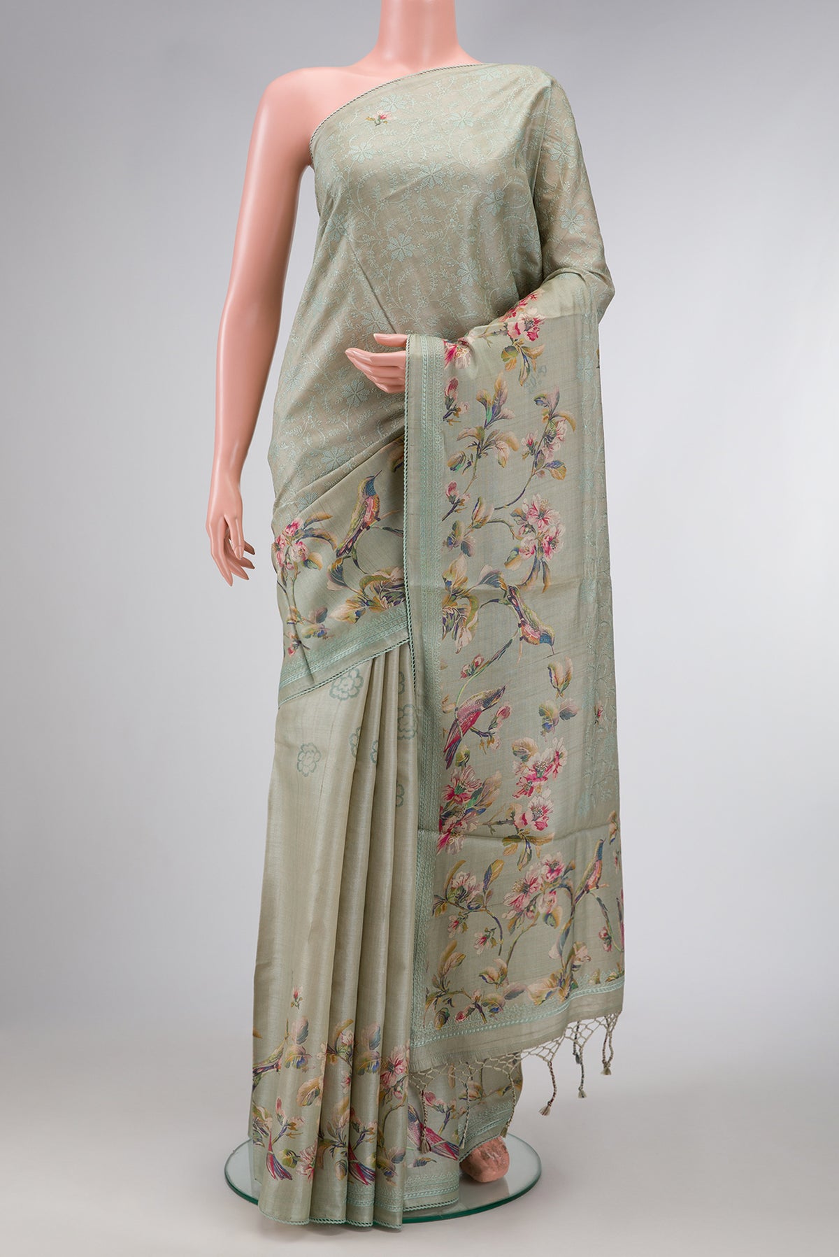 Grey Dual Tone Tussar Silk Saree with Printed design on the body and Embroidery Border.  displayed on a mannequin
