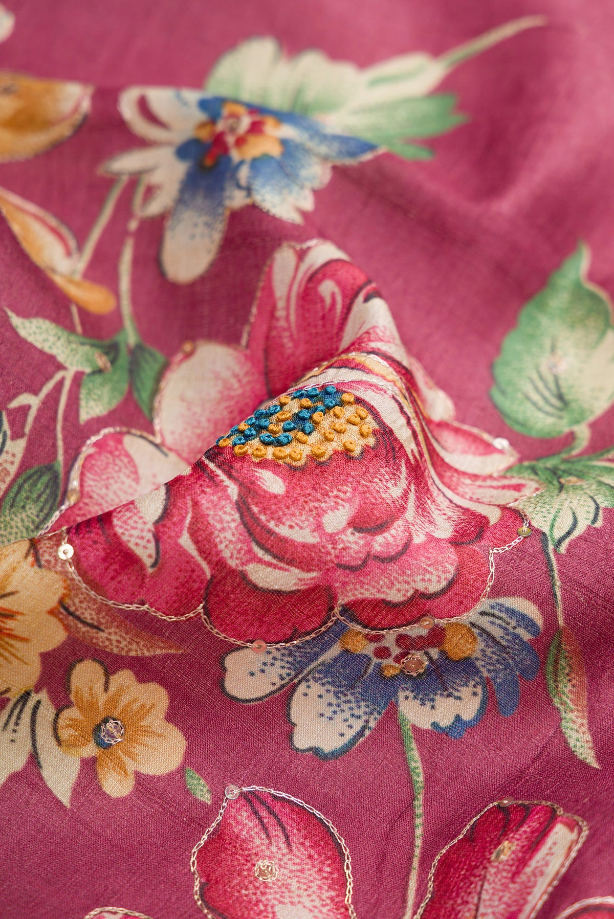Close up of Pink Dual Tone Tussar Silk Saree with Printed design on the body and Embroidery Border.  displaying folds