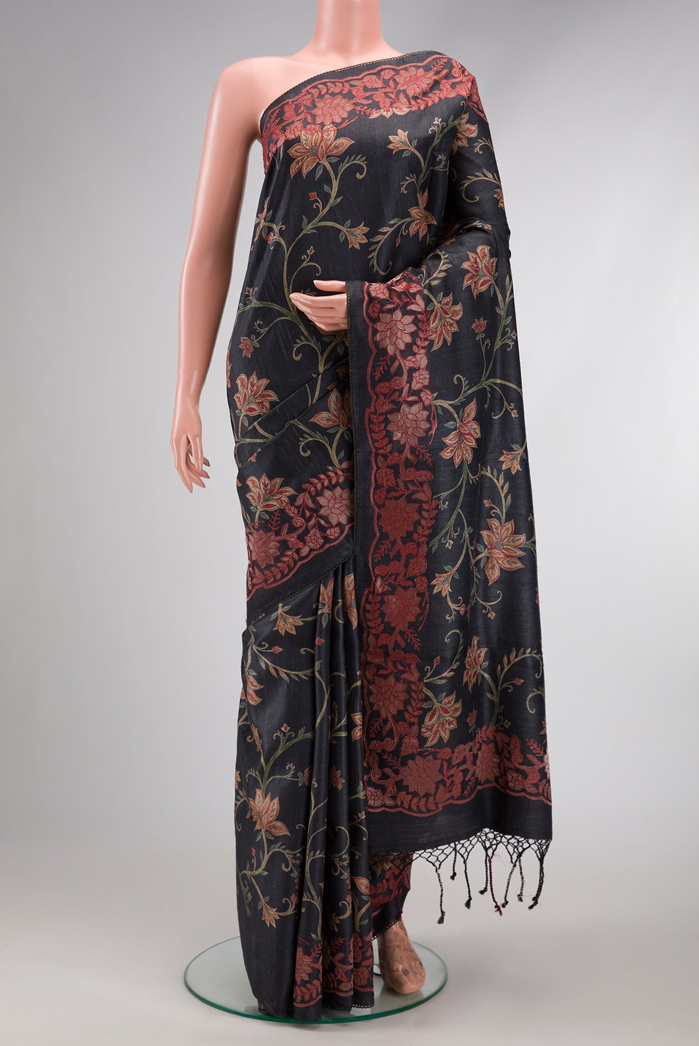 Black Dual Tone Tussar Silk Saree with Printed design on the body and Embroidery Border.  displayed on a mannequin