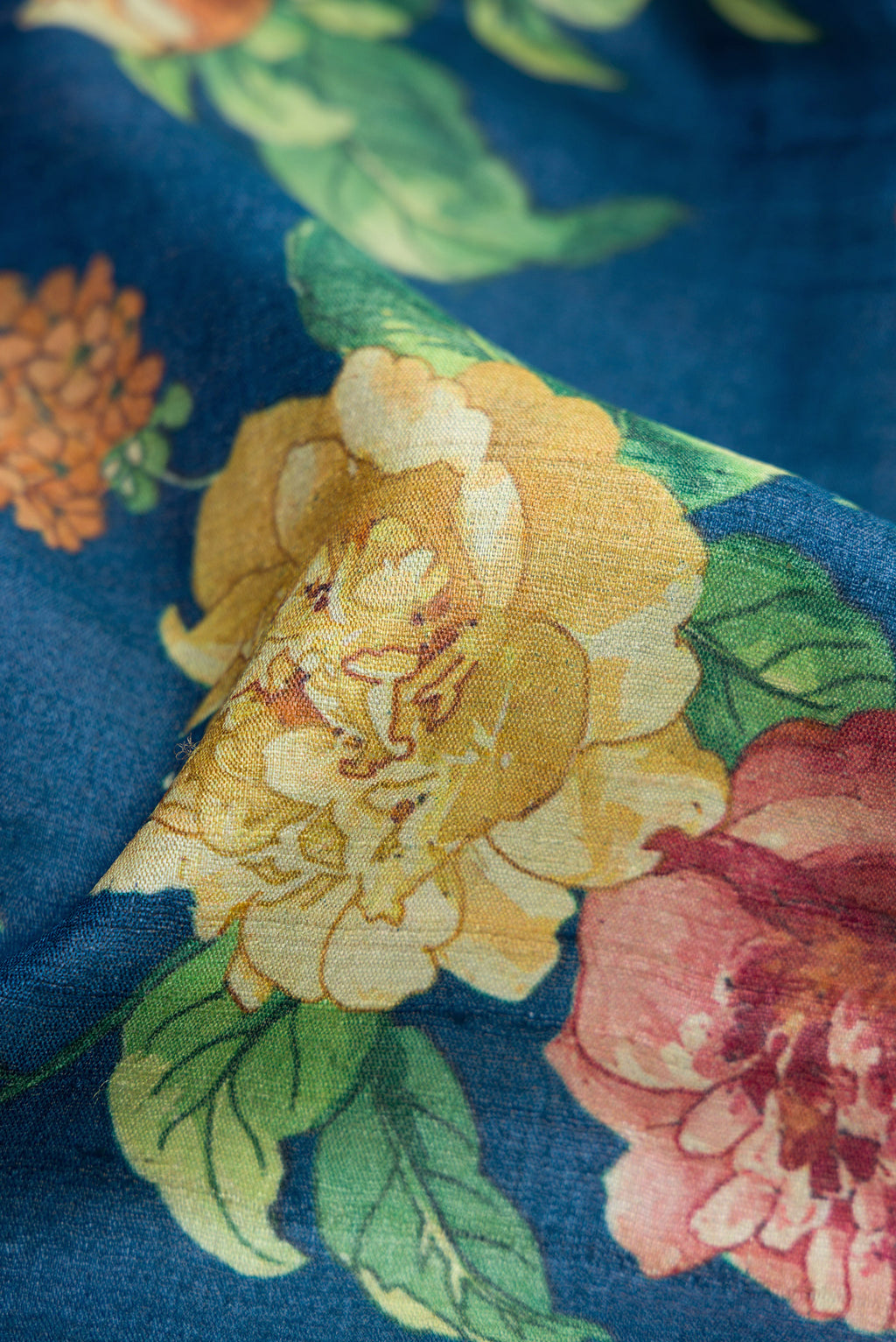 Close up of Navy Blue Dual Tone Tussar Silk Saree with Printed design on the body and Plain Border.  displaying folds