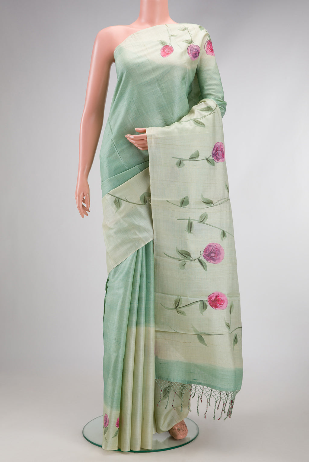 Pista Green Dual Tone Tussar Silk Saree with Plain Body and Fancy Border.  displayed on a mannequin