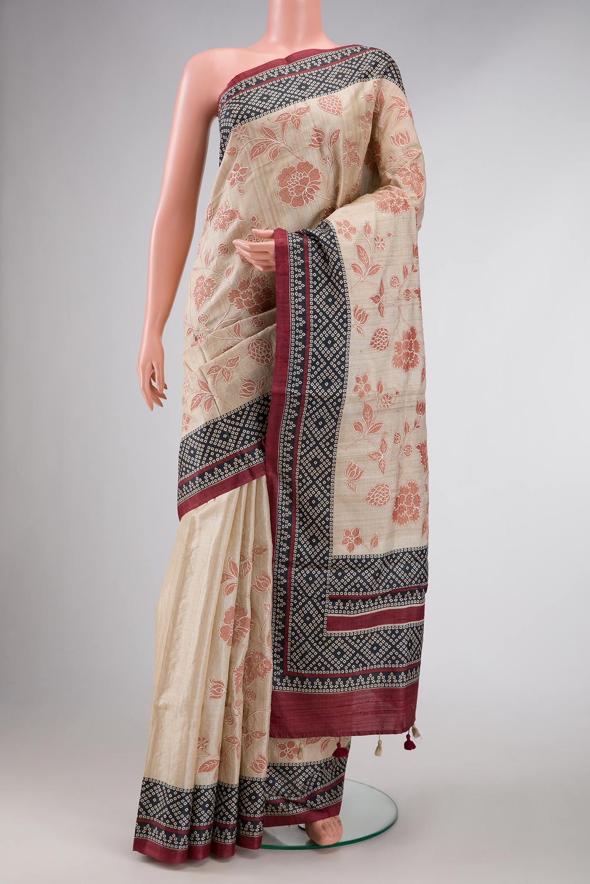 Beige Dual Tone Tussar Silk Saree with Printed design on the body and Printed Border displayed on a mannequin