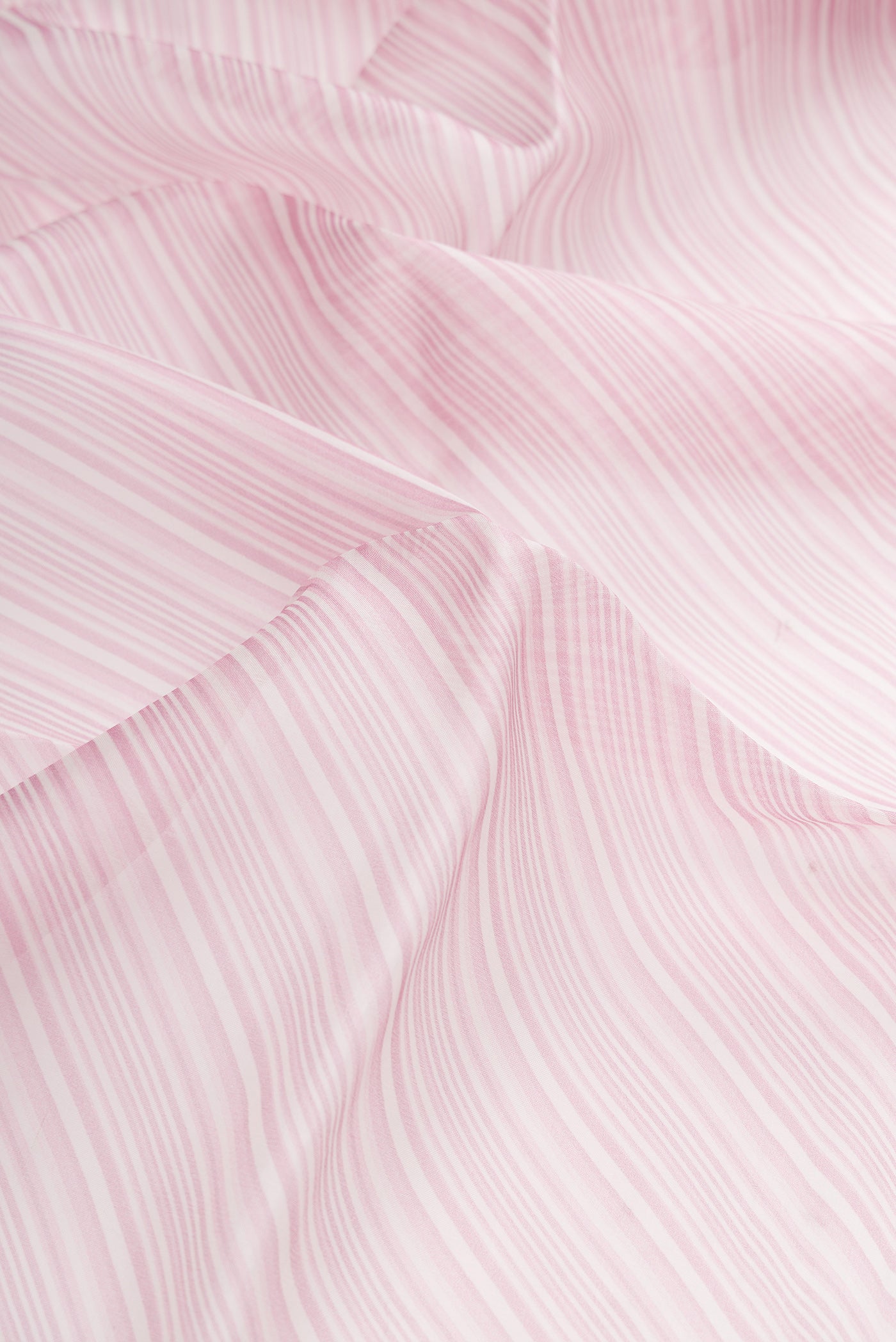 Close up of Lavender Dual Tone Organza Silk Saree with Printed design on the body and Embroidery Border.  displaying folds