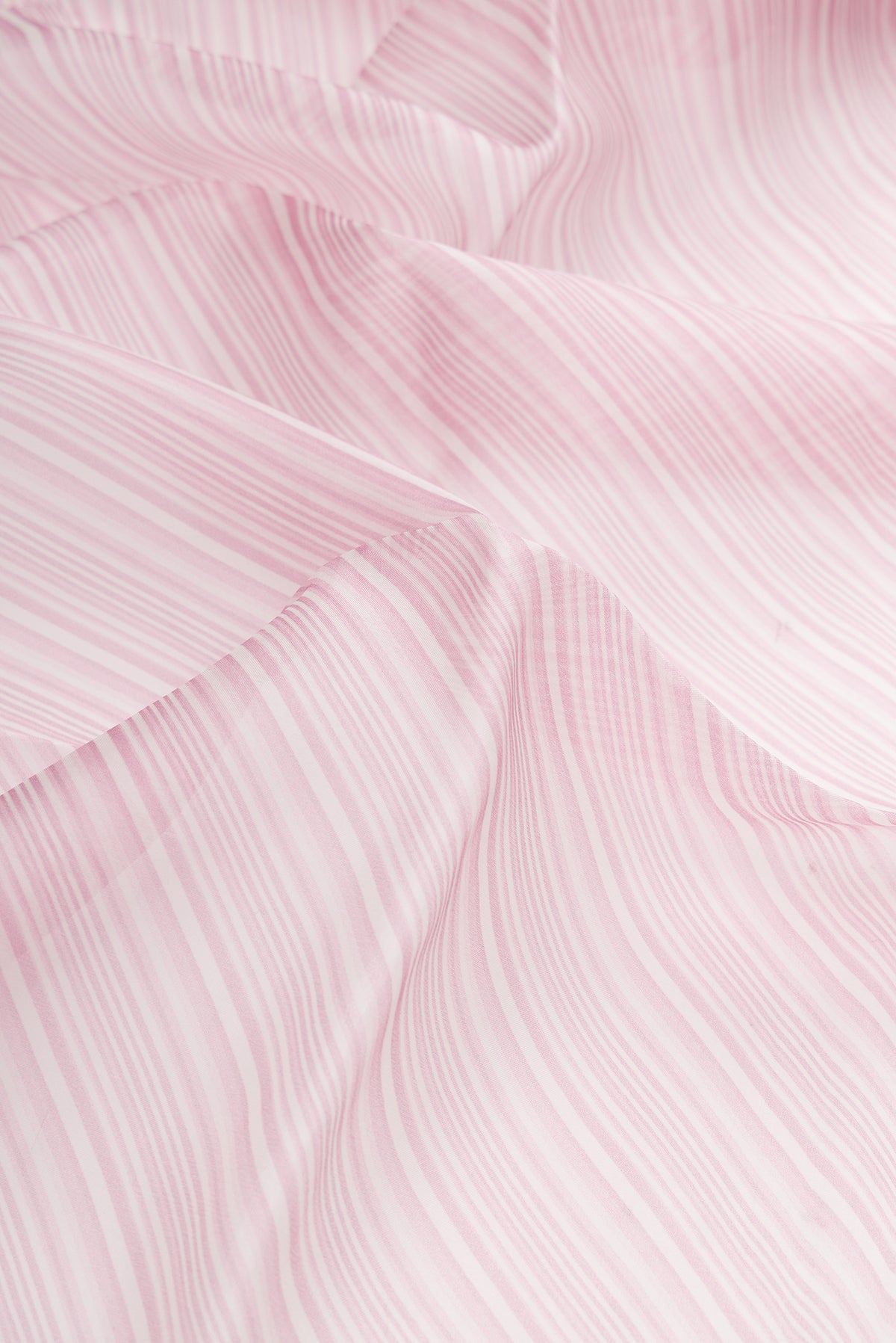 Close up of Lavender Dual Tone Organza Silk Saree with Printed design on the body and Embroidery Border.  displaying folds